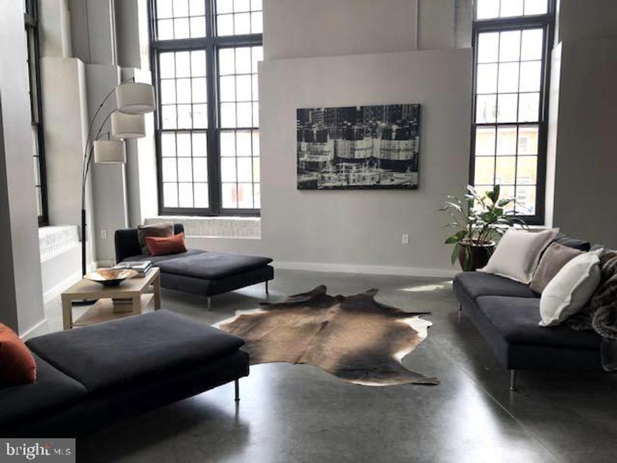 SUBSTANTIAL LIST PRICE REDUCTION OF $50,000!  Exceptional offering for this chic industrial loft condo in Canal Street Malt House!  The property is priced significantly below the assessment value and at a notably lower square footage price than other building and area comparatives.  The residence boasts 2,750 sq. ft. of stunning living space with a floor plan designed to maximize an incredible sense of openness and style.  The private entrance to the home is located on the Fawn Street side of the building. The main level features a captivating great room with dramatic walls of windows for tons of light, 18' concrete ceilings, a sleek kitchen with wood cabinets, granite counter tops, stainless steel appliances, kitchen island with breakfast bar, laundry/utility room, two bonus areas suitable for office space or an exercise area, and an en-suite bedroom/ bath with a large walk-in closet.  The en-suite master bedroom and sumptuous bath are located on the mezzanine loft. The home is enhanced with an unique blend of finishes of exposed ducts, columns, concrete, steel and brick, polished concrete flooring on the main level, spacious closets with custom build-outs, upgraded carpeting on upper level, designer lighting, ceiling fans, and deluxe remote controlled window shades.  The private patio is great for entertaining and has easy access from the rear to the parking garage.  One garage space #17 conveys, and is conveniently located within steps from the condo. Additional parking is available in the Little Italy Garage.  A designated storage space is provided in the common area in the rear of the garage. The Canal Street Malt House is ideally located and nestled among Baltimore's most vibrant neighborhoods and within close proximity to the Inner Harbor, award-winning restaurants, the new expanded Whole Foods Market, shopping, bars, highways, hospitals, and institutions. Major enhancements and business-residential development along the Central Avenue corridor and Harbor East continue to add to a superb community and a great urban lifestyle.  The finished square footage in the public tax record is incorrect.  Contact listing agent for a personal virtual tour of this amazing property.