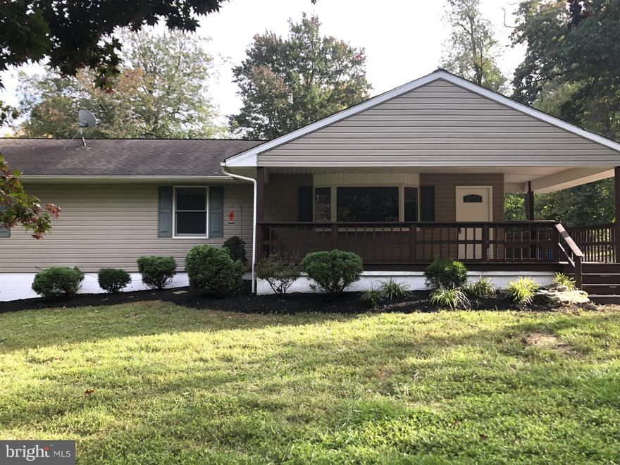 WOW!! Nice LARGE LOT!! Back off the road with plenty of privacy and breeze-filled trees. Updated kitchen with NEW granite. Hardwood floors thru-out. Finished basement complete with fireplace. LARGE wrap-around deck with ramp access off of the back. (Handicap accessible shower off main) SEE THIS ONE TODAY!!