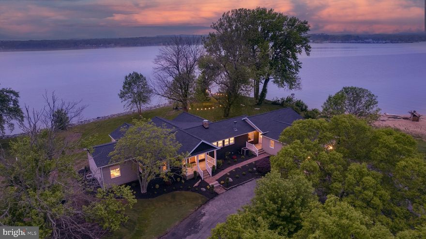 Welcome to your private waterfront paradise on the North East River. This beautifully renovated home stuns from the moment you arrive, offering peace, privacy, and the most amazing water views from nearly avery part of the home.

Inside, vaulted ceilings and expansive windows flood the home with natural light. The gourmet kitchen and spa-inspired bathrooms were designed by Colebrook Designs (see their work on Instagram) with refined attention to detail. Every element is crafted to highlight the home’s most spectacular feature — the water.

The great room welcomes you when you enter the front door, and commands attention with a vaulted ceiling, dramatic fireplace, and show-stopping river views. The adjacent kitchen is a chef’s dream, featuring a high-end stove, wet bar, custom soft-close cabinetry, and an oversized island with seating for four — all framed by wall-to-wall water vistas. A second living area offers a second cozy fireplace for relaxed evenings.

The main-level primary suite is a retreat in itself, with a soaking tub, walk-in shower, and sweeping river views. An additional bedroom and a second full bath complete this wing, perfect for one-floor living.

On the opposite side of the home, you'll find two more guest bedrooms with stunning views, a luxurious full bath, and a 5th bedroom build out as a stylish bunk room with custom build bunk beds — perfect for kids or visitors.

Step outside to take in the beautifully landscaped grounds bursting with color in spring and summer. A spacious cedar deck, private hot tub patio, waterfront fire ring, and a charming swing/daybed area create an outdoor haven. The driveway doubles as a pickleball court, and the adjacent beach makes summer days unforgettable.

Whether you're seeking a full-time dream home or a high-end vacation rental, this property delivers. One of the few on the market of this quality that can actually cash flow as a fully turn key, by right vacation rental, it's a unique opportunity. Homes like this don’t come along often, schedule your private tour today and experience waterfront living at its finest!