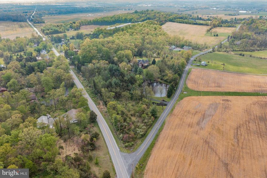 SOLD BEFORE PROCESSED! When you see the brick accent wall driveway entrance and the pond with a fountain - then you know you've arrived HOME.  Follow the driveway around the pond and you'll arrive at this spectacular grand brick Victorian home. The moment you see the balconies and the side porches you will know you are going to see a one-of-a-kind home. The brick walkway leads you to the massive 2 story brick covered front porch and covered side porch with archways. Through the glass front door, the foyer can be seen and your heart races, because THIS is what you've been searching for!  Step into the foyer and onto the marbled floor and gasp at the curved open staircase.  Once you catch your breath go left to the sunken sitting/living room.  Almost all the rooms in the home have double crown molding.  Walk past the staircase to the fabulous formal dining room with tons of windows and sparkling chandelier. Next, the kitchen is a chef's dream with porcelain tile floors, granite countertops, Subzero refrigerator, and a big island with built-in ice maker.  The 6-burner gas stove with built-in griddle & double oven is accented with a curved brick archway surrounding it.  A huge dining area with another chandelier completes this perfect space.  The sunken family room off the kitchen has a corner brick wood burning fireplace and has access to the side porch.  Head down the hallway, with picture frame molding, to the wonderful office with lots of windows and a gas fireplace, the laundry room with sink & storage, and a guest bedroom with a jack and Jill bathroom for access from the bedroom or the hallway.  Upstairs the owner's suite will steal your heart with skylights, cathedral ceilings, massive walk-in closet, corner gas fireplace and access to the balcony. The bathroom has marble floors, a massive soaking tub and marble double shower with 3 shower heads. There are 3 other big bedrooms on this level, one with access to the balcony, and another with a walk-in closet.  Down to the lower level for more surprises...The 2nd family room has a projector for movie time.  There is a huge recreation/game area, which the pool table can stay if desired, and there are 2 more bedrooms and another full bath!  3 storage rooms, 1 is enormous with countless shelves for tons of storage.  Onto the outdoor space...in addition to the front porch, covered side porch and 2nd story balcony, the fully fenced in backyard is breathtaking and can easily be your staycation location.  The big brick deck overlooks the beautifully landscaped yard and has electric awnings that will shade you on those super sunny days; but if that still doesn't keep you cool, take a swim in your inground pool with depths of 4'-12' which is complete with a slide. Cute gazebo on one side, and a separate pool house with a kitchenette, full bath, electric baseboard heat, ceiling fan and skylight, giving you additional studio living space.  The attached, side entry, 3 car garage has access into the laundry room, and it also has steps going down into the recreation room.  One more surprise....Off to the side, and out of view from the main house, is a fully working garage with a separate entrance. It has a Morton Pole Building with 3 oversized bays, (2 double bays & 1 single), office, storage & restroom.  The separate 50 x 25 RV port can easily fit 4 dump trucks.  This home with a new roof, sits on over 15 acres of land putting it in CLEAN & GREEN! There are also 3 wells: one for house, one for shop garage, and one by pond.  This home checks all the boxes, and with a total of 7 bedrooms and 5 full bathrooms, it can easily accompany multi-generational living if needed.  After all this, there's only one thing left to say....WELCOME HOME!