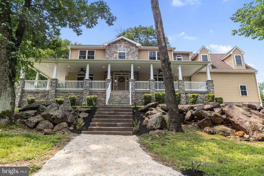 Welcome to 3137 Laughead Lane—a modern farmhouse tucked away on a quiet cul-de-sac in the award-winning Garnet Valley School District. With over 5,100 sq ft of thoughtfully designed space and no HOA, this home combines timeless character with refined design and exceptional craftsmanship, creating an atmosphere of elegance and comfort tailored for family living.

The full 720 sq ft wraparound stone porch faces east, offering a serene setting to enjoy peaceful sunrises or year-round entertaining. Equipped with recessed lighting, ceiling fans, and Bluetooth speakers, this outdoor living space extends the home’s inviting atmosphere. Two separate front entrances provide practical flow—one opens into the foyer, complete with a coat closet for guests or additional storage, while the other leads directly into the mudroom, featuring built-in shelves, hooks, and a coat closet—perfect for managing everyday comings and goings.

Inside, the main level features 9 ft ceilings and an open, purposeful layout that is sun-drenched by natural light streaming through expansive windows. The granite U-shaped kitchen boasts two sinks, two refrigerators, a walk-in pantry, ample counter space, a central island, and a breakfast bar. It connects seamlessly to the adjacent dining and living areas. A striking three-sided propane fireplace fashionably separates the living room from the adjacent sitting room. The living room includes built-in surround sound, ideal for immersive movie nights or lively gatherings, while the sitting room offers a wet bar—perfect for entertaining or unwinding.

A dedicated office with dual granite workstations and ample storage supports work-from-home and study needs. A tasteful powder room featuring an accent tile wall completes the main floor.

Upstairs, the primary suite serves as a private sanctuary with dual walk-in closets—one especially generous—a cozy sitting area, and a spa-inspired bath with jetted tub, walk-in shower, dual vanity, built-in shelving, and personal heat control. Three additional bedrooms offer spacious, light-filled accommodations with serene views. A beautifully finished hall bath and second-floor laundry complete this level for added convenience.

The finished basement impresses with 10 ft ceilings and flexible living space. It includes a full bath, kitchenette, and private flex room—well suited for a private office, gym, media room, game room, or guest quarters. With full egress, interior access, and direct garage entry, this level also lends itself to in-law or multigenerational living.

The oversized three-car garage features an 18 ft ceiling two-car bay connected to a separate 15 ft ceilings one-car bay, offering generous space for vehicles, storage, or creative projects.

The terraced front and back yards offer thoughtfully crafted multiple levels that provide distinct spaces for outdoor living, play, gardening, and entertaining. The heated fiberglass inground pool and spa offer a tranquil retreat surrounded by custom stacked stone walls and extensive hardscaping. A back patio off the rear door leads to stepping stones that guide you to the fenced-in pool area. An inground stone fire pit and a large poolside outdoor movie screen complete the outdoor experience, while a fenced garden provides a private space free from wildlife for reflection or gardening.

Additional features include a privately owned propane supply, radiant heated floors on the basement and main levels, and an efficient all-in-one heating system with hot water baseboard heat on the top floor for year-round comfort. The seller will provide a one-year home warranty through Choice Home Warranty, purchased at settlement and issued in the buyer’s name.

This home perfectly balances timeless elegance and modern comfort, designed to enrich every chapter of your family’s life.