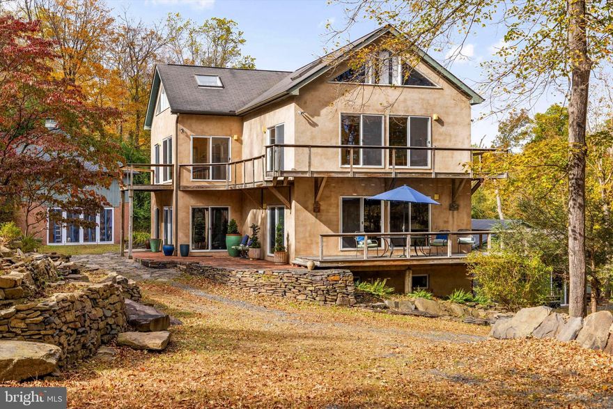 A rare Bucks County property offering endless possibilities for creative living, extended family, or entrepreneurial ventures. Set on a hillside with panoramic views of nature and seasonal glimpses of the Delaware River, this unique estate includes multiple residences with flexible spaces ready to inspire. The Main House is a modern and spacious 3-bedroom home with sweeping views — a peaceful retreat overlooking the river valley. The Carriage House contains a garage and studio above. The Gable House is a charming 2-bedroom dwelling full of character that is income producing or could be used for extended family and guests. The Barn House is a versatile building featuring income producing studio apartment and a 2-bedroom apartment — ideal for rentals, workspaces, or artist residencies. With so many living options, the property is well-suited for multi-generational families, collaborative households, or those seeking live/work flexibility. Artists and entrepreneurs will find abundant space to create, host, or generate income.
It's just a short walk to the Delaware River and the riverside village of Point Pleasant, with direct access to the towpath for biking and hiking. Nearby, enjoy the vibrant cultural scenes of Frenchtown, NJ, New Hope, PA, and Doylestown, PA.
Commute time is under 2 hours to NYC, 80 minutes to Philadelphia, and 50 minutes to Princeton — making this the perfect retreat or full-time residence for those looking to blend work, creativity, and lifestyle.