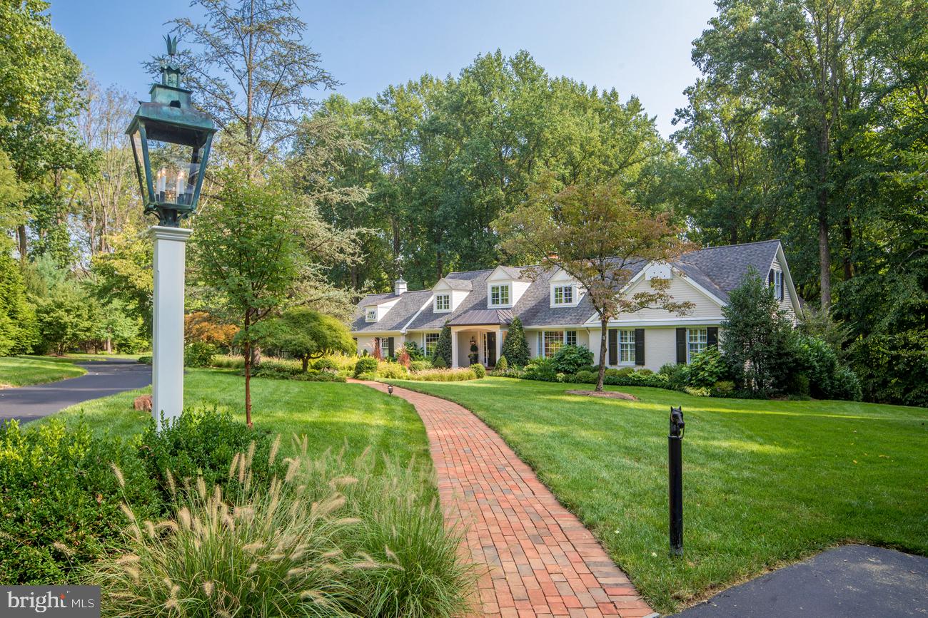 Wonderfully private and tranquil feelings surround you as you approach this Willistown 4 acre property. Approach this home down the long lantern-lined drive, and find an impeccably updated 5 bedroom, three and a half bath home. Brick pathway approaches front door with elegant entry. Living Room and Dining Room both feature floor to ceiling bay windows. The eat-in Kitchen has been completely remodeled and enlarged to fit a generous island. All the best appliances every chef wishes for, including Wolf range, double wall ovens, and a Subzero. Ceiling is two-story with skylights. Sliders to a brick patio with pergola and fountain create an oasis worth escaping to, terraced to a well-sized yard where one could easily play sports and entertain . Off the Kitchen is convenient powder room, mudroom, and entrance to oversized 2 car garage. Adjacent to the Kitchen is a vaulted-ceiling Family Room with skylights and plenty of windows, bringing in loads of natural light, and a large fireplace to warm yourself on cold winter nights. The bedrooms and baths are set up in a very convenient main floor plan, including the Owner's Suite with spacious seating area and newly remodeled bathroom, plus two more bedrooms, a den, and a recently remodeled hall bath. Upstairs is beautifully detailed with two more bedrooms, a full bath, and access to extra large attic space. Walk-out Lower level is unfinished but plumbed for bath. This property sits in the middle of gently rolling hills and luxury horse farms, yet still it is only minutes away from train, shopping, and major highways. Whole house generator. Don't miss this flawless gem!
