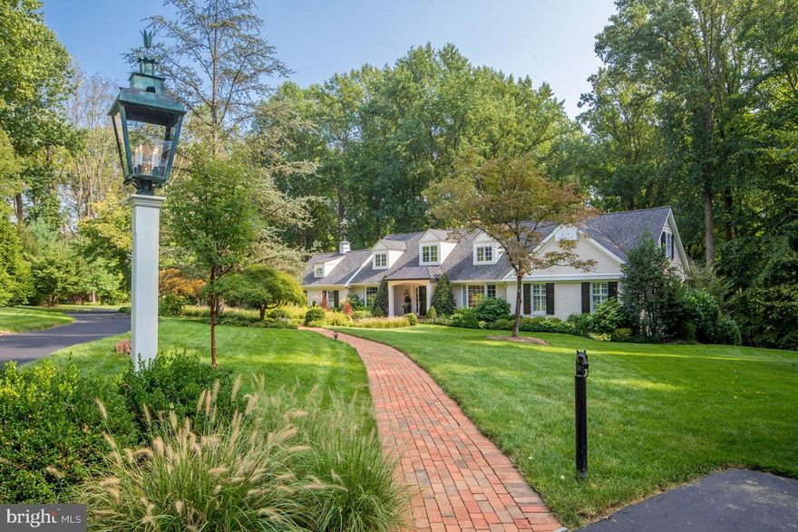 Wonderfully private and tranquil feelings surround you as you approach this Willistown 4 acre property. Approach this home down the long lantern-lined drive, and find an impeccably updated 5 bedroom, three and a half bath home. Brick pathway approaches front door with elegant entry. Living Room and Dining Room both feature floor to ceiling bay windows. The eat-in Kitchen has been completely remodeled and enlarged to fit a generous island. All the best appliances every chef wishes for, including Wolf range, double wall ovens, and a Subzero. Ceiling is two-story with skylights. Sliders to a brick patio with pergola and fountain create an oasis worth escaping to, terraced to a well-sized yard where one could easily play sports and entertain . Off the Kitchen is convenient powder room, mudroom, and entrance to oversized 2 car garage. Adjacent to the Kitchen is a vaulted-ceiling Family Room with skylights and plenty of windows, bringing in loads of natural light, and a large fireplace to warm yourself on cold winter nights. The bedrooms and baths are set up in a very convenient main floor plan, including the Owner's Suite with spacious seating area and newly remodeled bathroom, plus two more bedrooms, a den, and a recently remodeled hall bath. Upstairs is beautifully detailed with two more bedrooms, a full bath, and access to extra large attic space. Walk-out Lower level is unfinished but plumbed for bath. This property sits in the middle of gently rolling hills and luxury horse farms, yet still it is only minutes away from train, shopping, and major highways. Whole house generator. Don't miss this flawless gem!