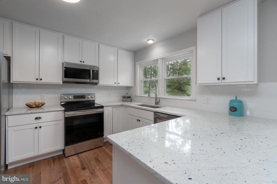 This beautifully renovated property offers all the updates on over 1 acre in a lovely established neighborhood with NO HOA . Boasting a HUGE  detached workshop and home is in a  sought after school district .  Luxurious interiors blend with a flowing floor plan with NEW hardwood floors and carpets, new paint, lighting and 3 remodeled FULL baths.  NEW kitchen features sleek granite countertops, modern white cabinetry,  subway tile backsplash and NEW Stainless appliances.  Just off the  kitchen area you will discover the dining  room highlighted by the cozy whitewashed fireplace. The open living room makes a great place to relax and join the activities in the kitchen. Enjoy the beautiful outdoors while sipping  your morning coffee  on the fantastic 2 tiered deck overlooking the  private lot. Lots of extras on this property to include an additional 24 x 36 , 2 level, heated, 3 car detached garage. Separate electric and new LED lighting.  Perfect for working at home, car enthusiast  or large hobby projects;  bring your toys!  The oversized driveway provides ample parking for many cars, a boat or RV.   The master bedroom boasts a barn door leading to the luxury tiled bath w/ double sinks, large walk in closet , and separate water closet with oversized shower.  The finished basement has a large rec room with a 2nd  fireplace, 4th bedroom, 3rd full bath and a full walk out.  Plan barbecues or family gatherings on the fantastic refurbished deck.   Other major improvements include but are not limited to all NEW energy efficient windows and sliders, 3 new garage doors, 2 new fireplace liners and NEW Architectural shingles on the home, fresh paint on the home and outbuildings as well as a new landscape package!