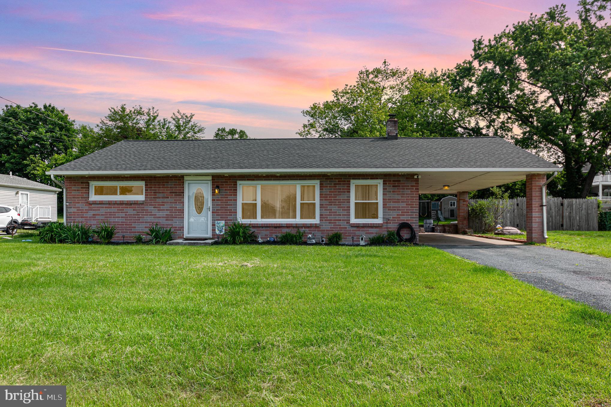 Welcome to this solid, updated 4 (potential 5) bedroom, 2 full bath rancher in Perry Hall that sits in a quiet neighborhood just seconds from Bel Air Rd and just minutes from Rt 43, I-95 and tons of shopping/dining destinations. Pull into the driveway or park in the covered carport and enter into the main level of the home. Entering through the front door of the home brings you into a large open concept living room/dining room area covered in luxury vinyl plank flooring with bay windows to allow for plenty of light to enter the home. A short hallway off of the living room leads to two bedrooms and a modern full bath with custom tile flooring quartz vanity, and tub/shower combo. Back in the living/dining room area, a side door leads in and out of the carport, and the kitchen sits right off of this dining area. The kitchen has custom cabinetry, all stainless appliances and a painted brick backsplash. In the rear of the kitchen a back door opens out onto a large beautiful custom paver patio with low walls, and a built in fire pit that overlooks the rear yard. The large rear yard is cleared and full fenced with privacy fencing and has two sheds for your storage/lawn care needs.
The fully finished basement adds tons of living space for play or relaxing with a second living room, an office, a second modern full bath with walk in shower, a laundry room with washer/dryer and wash sink, as well as a utility storage room and two more finished rooms that could be converted to bedrooms. This house has it all, is in a great location and has a 2 year old roof and 7 year old HVAC, its move in ready and modernized and waiting for you!