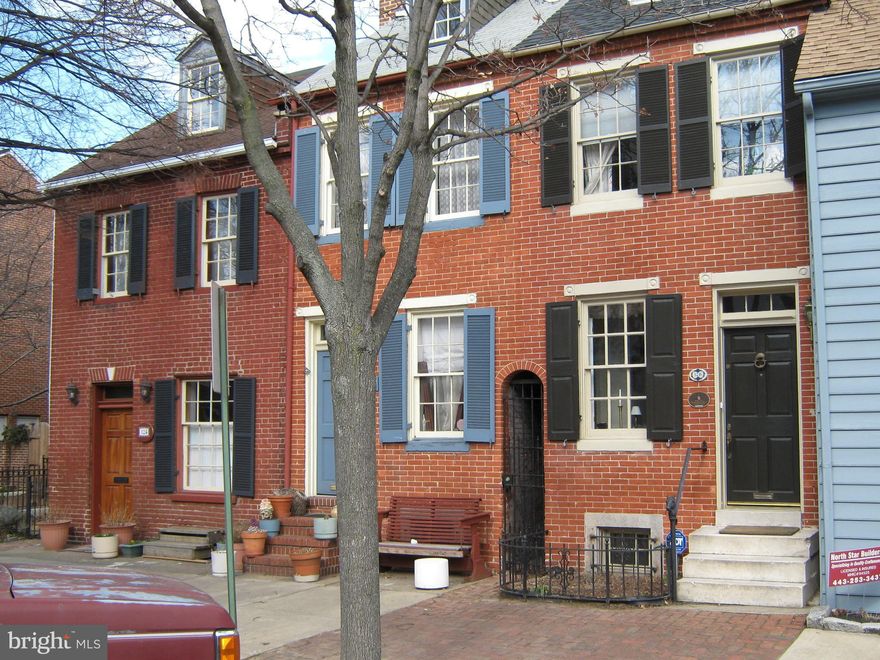 An 1825 Historic Home nestled on the renowned cobblestone block of Montgomery Street. Steps from Federal Hill Park and the Inner Harbor. Five decorative fireplaces, original pine floors, remarkable master bath with whirlpool tub. Roof top deck with custom railing offers city and harbor views. Raised brick patio in rear. POOL BOND INCLUDED.