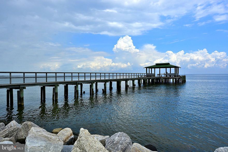 SELLER SAYS SELL!!!! HUGE PRICE REDUCTION!!!! Not often does an updated home only steps to the beach come on the market. Wake up and enjoy coffee on your deck with great views of the Chesapeake Bay. Boating, fishing, community events, swimming, crabbing, and more are right outside your front door. Come home in the evenings and enjoy an adult beverage while wathcing the glistening waters of the bay. The home has a large family room that boasts natural light. While sitting in your family room make sure and enjoy your water views. The kitchen is updated with wooden cabinets, new appliances, and beautiful tile. The bathrooms display the attention to detail with custom stone and lighting. Your wrap-around porch exits to a backyard with more views of the water. Park your boat in the marina and enjoy the short boat rides to local restaurants with live music. Whether you are fishing with friends, hosting a crab feast, or strollingthe beach to collect driftwood, you truly will be vacationing where you live. If you're looking for a second home with potential AirBnB rental income... look no more!