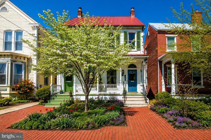Priced to Sell! Located in the heart of Downtown Frederick on the quieter end of town, this charming 3-level home offers the perfect blend of historic character, walkability, and future potential. Enjoy your morning coffee and newspaper on the sunny front porch, then unwind in the beautifully private rear garden — a true secret garden filled with seasonal blooms, fenced for privacy, and leading to convenient alley parking. The cozy breakfast room offers peaceful garden views year-round, even on rainy days.
Just a short stroll to vibrant downtown shops, restaurants, Carroll Creek, bakeries, art galleries, breweries, and Frederick’s beloved arts and crafts scene, this location offers an exceptional, walkable lifestyle. Enjoy easy access to local favorites, community events, festivals, and scenic creekside paths right outside your door.
Inside, the home retains much of its original charm while offering important updates that count, including a newer roof with added insulation. The appliances are young, and the washer and dryer are newer as well. The upper floors offer amazing city views and abundant natural light throughout.
With excellent bones and timeless character, this well-loved home is patiently awaiting your cosmetic touches and final improvements to truly make it shine. 
A rare opportunity to own a charming downtown Frederick home with incredible walkability, character, private outdoor space, and endless potential. This one is worth a second look!