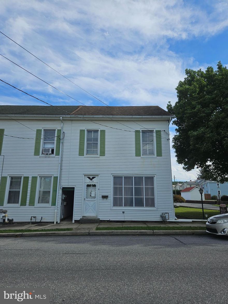 Large 2 story home in the heart of Topton Borough.  This Home features a spacious living room floorplan that leads to a dining room and remodeled eat-in kitchen with bath and first floor laundry. Front and rear staircases lead up to the second floor with 3 bedrooms, full bath, and a large walk-up attic.  There is a rustic brick woodstove nook by the back door with access to a covered porch sitting area. Home has a newer high efficiency gas furnace and some newer replacement windows.  Within walking distance to the community park, schools and restaurants. Home is in need of paint and cosmetic upgrades throughout.