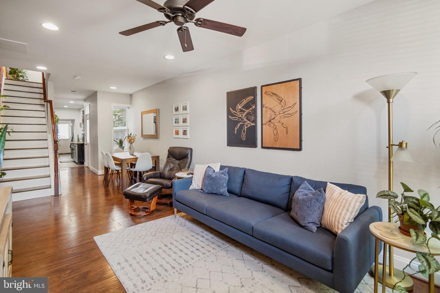 Meticulously maintained 3-bedroom, 2.5-bathroom Canton rowhome with a parking pad and two-tiered rooftop deck showcasing stunning city and water views! Gleaming hardwood floors and exposed brick walls create a warm, inviting atmosphere. The spacious living room easily accommodates a large sectional, ideal for entertaining. The dining room flows seamlessly into the kitchen, which features a wine bar, granite countertops, and stainless steel appliances. The upper level offers two bedrooms, a full bath, and access to the rooftop deck. The fully finished basement includes an additional bedroom, full bath, laundry and ample room for storage. Enjoy the convenience of a main-level half bath and side and rear access to the parking pad/patio. Just a short walk to Patterson Park, Canton Waterfront Park, and Canton Square.