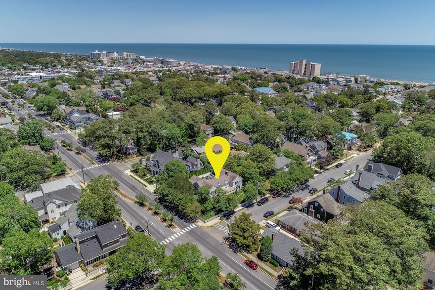 Introducing 125 Stockley Street! This stunning 6 bedroom, 5.5 bath home is situated on a double lot (100' x 100') and only 2 blocks from the beach. Renovated in 2011, this home seamlessly blends coastal cottage charm with modern day amenities. The first floor offers expansive spaces to entertain including a living room with hardwood floors, wood burning fireplace with marble surround, an additional seating area, and formal dining room with crystal chandelier. Step outside onto the spacious hardscape patio which is surrounded by beautiful mature landscaping with irrigation. Adjacent to the dining room is the large gourmet kitchen which boasts granite counters, subway tile backsplash, exposed wood beams, stainless steel appliances, 6-burner gas range, 2 dishwashers, additional ice maker, and warming drawer. Built-in seating creates a cozy eat-in kitchen and the space is completed with a pantry and wet bar with beverage fridge. Finally, a guest suite and a half bath complete the first floor. On the second level you will find a master suite with a spacious private deck, and luxurious bath including vaulted ceilings with tongue and groove wood paneling, tiled shower, double vanity with granite counters and soaking tub. In addition, a guest bedroom with en-suite bath, and 2 bedrooms adjoined by a Jack-and-Jill bathroom. A beautiful separate 2nd floor bedroom is located off the living room and accessed by a spiral staircase. This room features vaulted ceilings with tongue and groove paneling and private bath. Lastly, the 1.5-car garage and unfinished clean and dry basement provide you with an abundance of space for storage. This is a rare opportunity to enjoy Rehoboth Beach charm with all of today's modern luxuries.