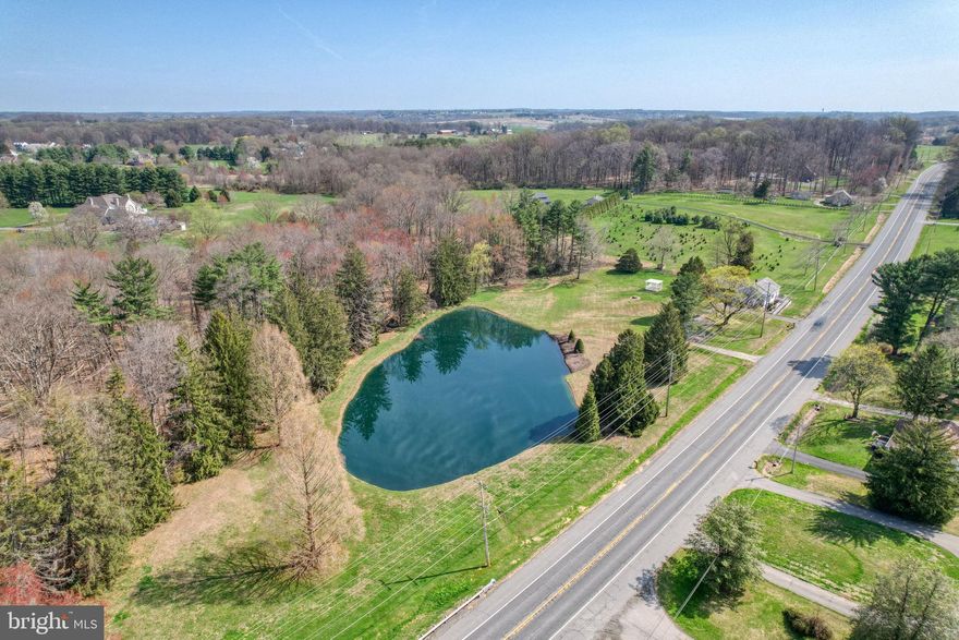 Welcome to your own private retreat in the heart of Fair Hill. Situated on over 4 scenic acres, this 3-bedroom, 2-bath home offers a rare combination of comfort, natural beauty, and convenience. The home features a spacious layout, along with a generous 30’ x 18’ ground-level workshop beneath the rear of the home complete with a garage door, perfect for hobbyists, storage, or creating your ideal workspace. A handicap-accessible ramp provides easy entry through the front door, and maple hardwood flooring lies beneath the carpet throughout the main living areas, offering additional potential.

One of the standout features of this property is the expansive screened-in porch overlooking a picturesque pond, creating the perfect setting to relax and enjoy peaceful views year-round. The property is further enhanced by mature trees, wooded surroundings, and a stream running through the land, offering privacy and a true connection to nature. Updated electrical system inside and out—an important upgrade already taken care of for you.

Located in the highly desirable Fair Hill area of Elkton, this home is just minutes from the Fair Hill Natural Resources Management Area, encompassing acres and acres of preserved land with miles of trails for hiking, biking, and horseback riding, along with fishing and year-round outdoor recreation. The area is well known for its equestrian culture and hosts nationally recognized events.

Enjoy the serenity of this private setting without sacrificing convenience, as the property is ideally located near major commuting routes for easy travel to Delaware, Baltimore, Philadelphia, and Washington, D.C. The area also offers close proximity to many marinas, waterfront dining, and abundant outdoor activities including boating, fishing, and kayaking. Just minutes away, the town of North East provides a charming atmosphere with boutique shopping, local dining, and community events. It is also within close proximity to world-renowned medical facilities.

An exceptional opportunity to make this rare gem your own—where privacy, nature, and convenience exist in perfect harmony, and your vision can transform it into something truly special.