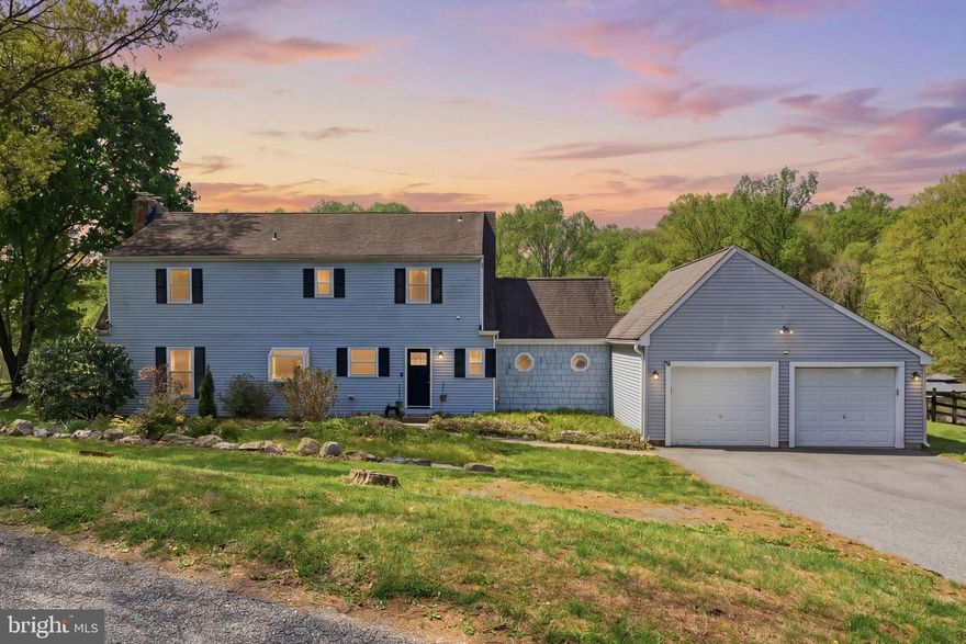 Set on nearly 3 private acres, this beautiful home delivers the perfect blend of peaceful retreat and entertainer's dream- all in one of the most coveted locations in the area. Minutes from Fair Hill Nature Center with its miles of trails and year-round events, a short drive to Newark's vibrant Main Street and the University of Delaware, and an easy shot into Pennsylvania, the location alone sets this home apart. The updated main level features a gorgeous kitchen with granite counters, white cabinets, subway tile backsplash, new plank flooring, and stainless appliances, flowing into a warm family room with a wood stove and two glass sliders that frame stunning views of rolling hills and a wooded rear yard. A bonus room serves perfectly as a 4th bedroom or home office, and the mud room with vaulted ceilings, wood beams, and custom cabinetry connects directly to the two-car garage. Upstairs, the owners suite impresses with a brick fireplace, barn-style closet doors, and a spa bath featuring a custom tile shower, dual vanity, and soaking tub with brass accents- plus two additional bedrooms and a sun-filled loft ideal as a reading nook or office. The lower level adds a rec room and plenty of storage. Outside is where this home truly shines — an 18x34 in-ground pool with slide and diving board, playground, firepit area, Edison-lit patio, and a fully fenced yard wrapped in mature trees for complete privacy. Warm evenings here mean a soft breeze, open land, and a golden sunset that reminds you exactly why you chose this home.