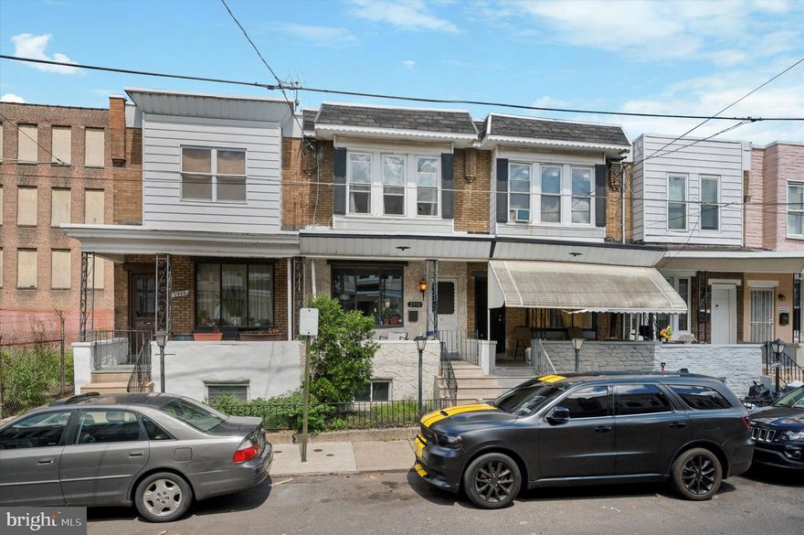 Welcome to 2950 Weikel Street – a charming 3-bedroom, 1-bathroom row home in the heart of Port Richmond. A cozy front porch and bay window greet you as you step inside to a bright, open-concept living and dining area. The space is enhanced by beautiful hardwood floors, custom wainscoting along the staircase, and an eye-catching coffered ceiling that adds character and charm. The eat-in kitchen is tucked away in the rear and features white shaker cabinets, a striking tile backsplash, modern appliances, and plenty of cabinet and counter space. Out back, enjoy a private concrete patio—perfect for relaxing or entertaining during warmer months. Upstairs, you'll find three bedrooms and a full bath. The primary bedroom sits at the front of the home with three windows, generous closet space, and a unique nook area tucked behind the door. The bathroom is finished with tile floors, modern grey accents, and a tub shower. This home also features an unfinoshed basement with laundry and space for additional storage. Located just steps away from local favorites like Nemi, Tacconelli’s, and more. With access to nearby parks and quick access to I-95, I-676, and public transit options like Route 15 trolley and the Market-Frankford El.
