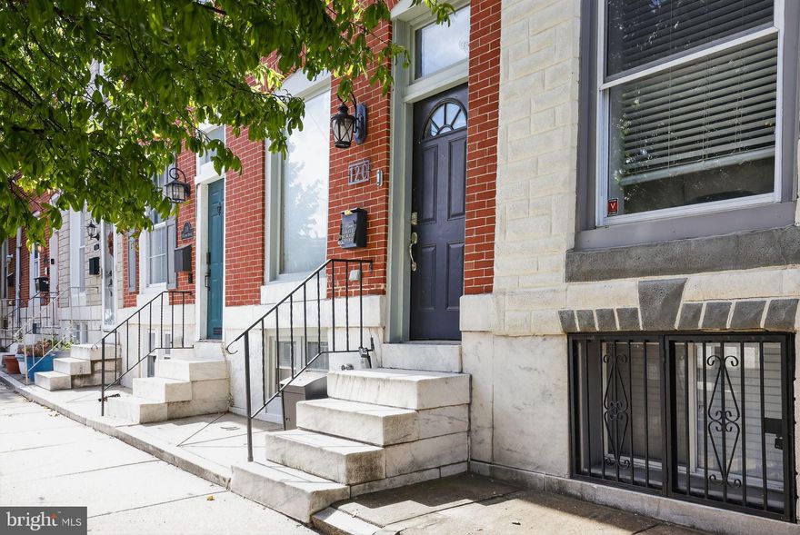 Welcome to this beautifully updated 3-level Patterson Park rowhome offering 1944sq. ft. of living space just one block from the park! The main level features an open floor plan with hardwood floors, a modern kitchen with granite counters, stainless steel appliances, gas cooking, and bar seating, plus a flexible dining area leading to a private fenced patio. Upstairs, the primary suite boasts built-ins, a soaking tub, separate shower, and private balcony. A second bedroom with vaulted ceilings and a hall bath complete this level. The fully finished lower level offers a bright family room with built-ins, full bath, laundry, and storage—ideal for guests, office, or media space. With central air, gas heat, and stylish finishes throughout, this move-in ready home combines charm, comfort, and an unbeatable location close to festivals, dining, and all that Patterson Park has to offer!