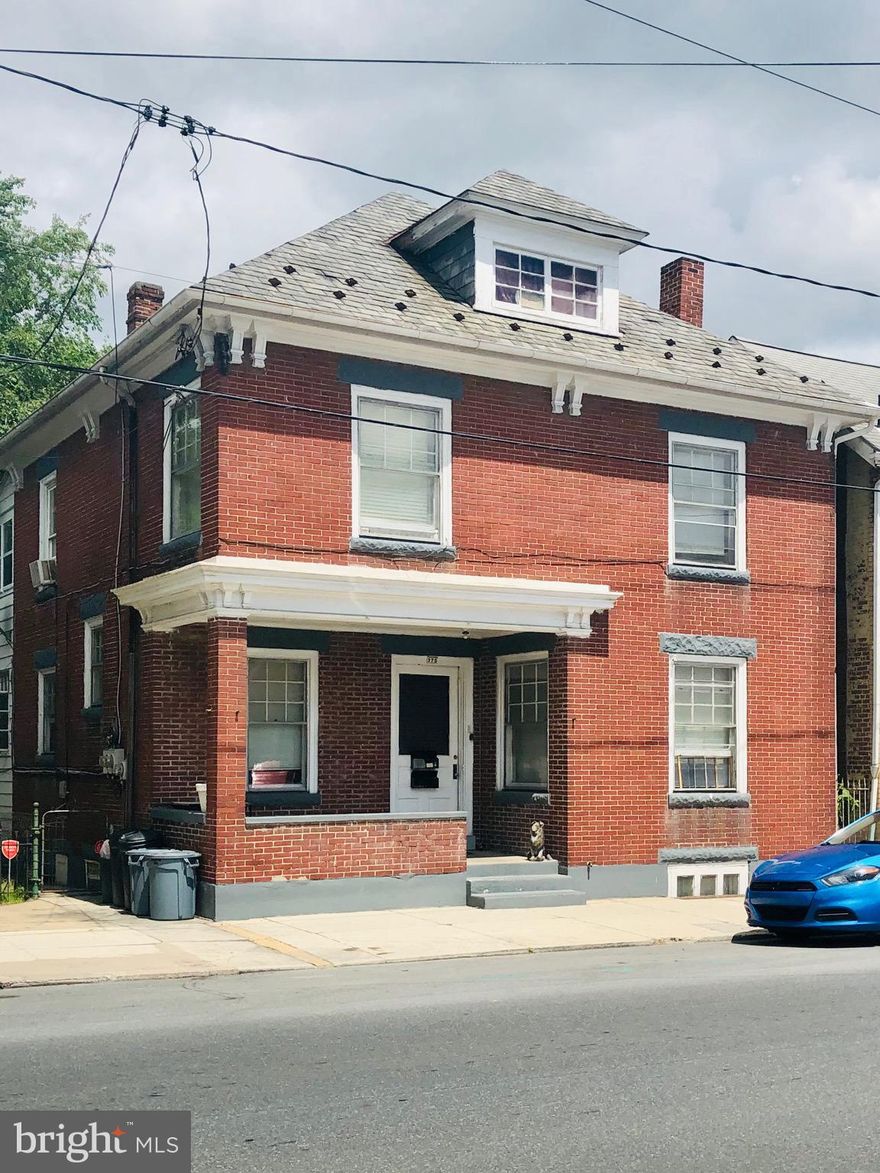 A must-see solid brick house in the Borough of Chambersburg! Well suited for an investment portfolio or an opportunity to live in one unit and rent the other.  This is a duplex with two bedrooms in each apartment and a large backyard that is well maintained and fully fenced. Upper unit has access to the attic that works for additional living space or extra storage and a private balcony with access to backyard from the rear.  First floor unit has access to partially finished and livable basement with lots of storage space and private access to backyard as well. Dual meters for electric. Low utilities on natural gas. There is additional income from the detached 3 unit garage as well.
