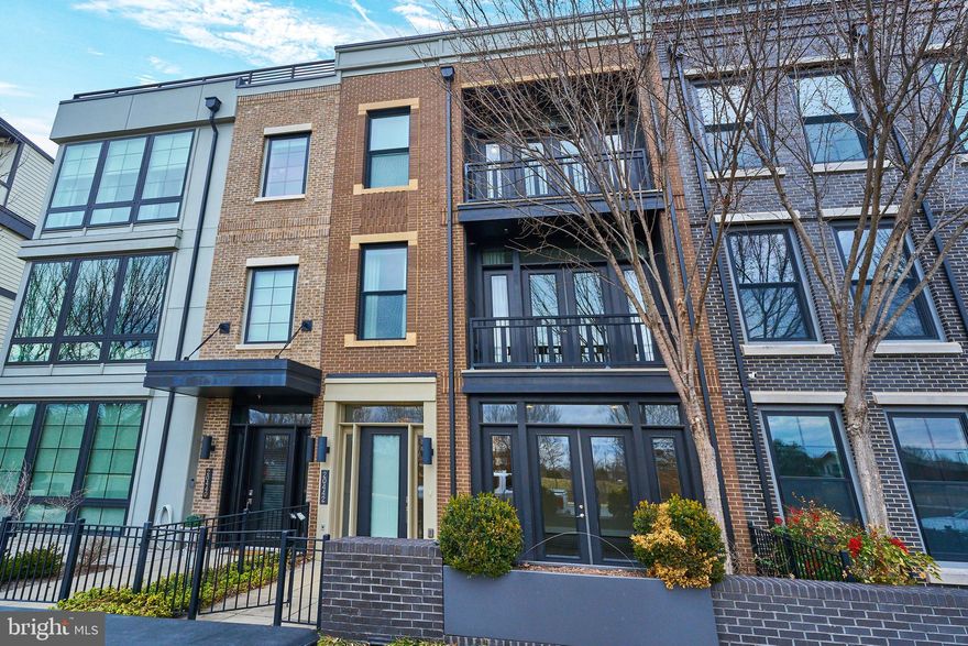 Luxurious four level Miller & Smith built home in sought after One Loudoun location with elevator features stunning finishes and features throughout. Upgraded hardwood flooring & lighting throughout the home. Large living room with custom window treatments and gas fireplace. Chef's kitchen with white cabinetry, two islands, upgraded appliances and large walk-in pantry. Large owner's suite with walk-in closet & spa like bathroom with oversized shower and soaking tub. Two spacious bedrooms, upgraded full bathroom and laundry room complete this level. The fourth level features a private den or work from home space, upgraded full bathroom and large entertaining space leading out to spacious roof terrace. The lower level features a large recreation room with access to the front courtyard, personal lobby/hobby area, full bath & access to the two car garage. This truly stunning home is conveniently located near restaurants, shopping, community amenities and commuter routes.