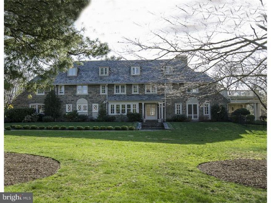 Welcome home. This stately stone mansion with 7 bedrooms and 4.1 baths sits on 2 level acres among the other estate homes near Merion Golf Club's East course. Gracious and classic, the first floor offers a through Center Hall, large bright living Room with fireplace, newer comfortable Library/Family Room with built-ins, gas fireplace, wet bar which includes an ice maker, mini fridge and dishwasher. French doors lead out to the pool and an alfresco dining area. There is a Den as well that has a fireplace. The Dining Room is spacious enough for any large family gathering with French doors from the hallway and entrance to the updated Kitchen and Butler's Pantry. The Kitchen has a gas cook top and copper hood, double ovens and the other pertinent amenities. The Powder Room is off the Hall. The second floor has a Master Suite with Dressing Room and updated Bath. Connecting to this is an additional room which could be an office or a nursery or an 8th bedroom. There are three other bedrooms and 2 additional baths as well as a laundry on this floor. The third floor has 3 Bedrooms, a living room and an updated Bath. The Basement is large and unfinished with laundry facilities. There is a newer steam furnace, hot air system and radiant heat system in the Library/Family Room. The grounds have been meticulously maintained with lovely gardens. A newer gardener's house sits above the pool.