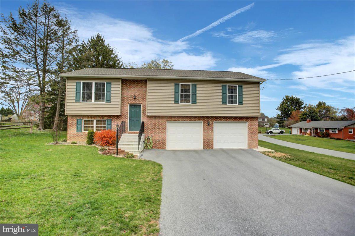 Attractive almost new Bi-level situated on a spacious .45-acre corner lot. Double oversized attached garage with additional side entry door for outside convenience. Modern exterior colors with brick and vinyl siding. Interior includes three bedrooms and two- and one-half baths. The upper floor consists of the primary bedroom with full bath, two more spacious bedrooms share the second full bath. All bedrooms have feel good carpet for comfort and warmth. The remainder of this floor enjoys easy care flooring. An expansive kitchen is open to the inclusive dining area, which has sliding glass doors opening onto a welcoming deck. The kitchen has solid countertops featuring a breakfast bar, stainless steel appliances, and a stainless double sink.
A generous light filled living room/family room completes the upper level.
In the lower level you will find another huge family room with sliding doors opening to a concrete pad and the large rear yard. On this floor you will also find the laundry room and half bath, a deep oversized garage giving access to the home, as well as the propane furnace. Economical propane gas and central air, current paint colors with all the other amenities make this a very desirable home to call your own!