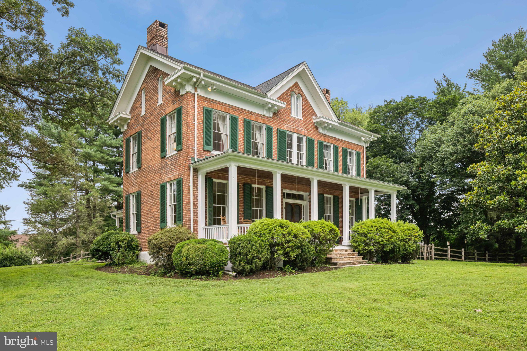 Historic Charm Meets Modern Comfort in Centennial Estates
Step into timeless elegance at 10212 Little Brick House Court, a gracious farmhouse built in 1865 and affectionately named “Shirley.” Set on a lush 1.5-acre lot, this stunning brick residence retains original hardwood floors, etched glass windows, and the romance of its storied past—rumored to have hosted Robert E. Lee—while offering all the conveniences of contemporary living. Entertain in style within the heart of the home: a bright, farmhouse-style kitchen outfitted with stainless steel appliances and ample space to gather. Spread across 3,850 sq ft are five well-proportioned bedrooms, including a generous owner’s suite with walk-in closet and dedicated laundry, plus three full baths. Additional rooms offer flexible spaces perfect for home offices, playrooms, or guest retreats. Beyond the interiors, enjoy a three-car detached garage, central air-conditioning, and thoughtfully maintained grounds shaded by mature trees. The beautiful porches beckon for morning coffee, afternoon unwinds, or sunset evenings. Perfectly positioned, the home also offers easy access to Historic Ellicott City’s vibrant Main Street, scenic trolley trails, parks, and dining. A rare opportunity to own a true piece of Maryland heritage, this one-of-a-kind property is ready to begin its next chapter.