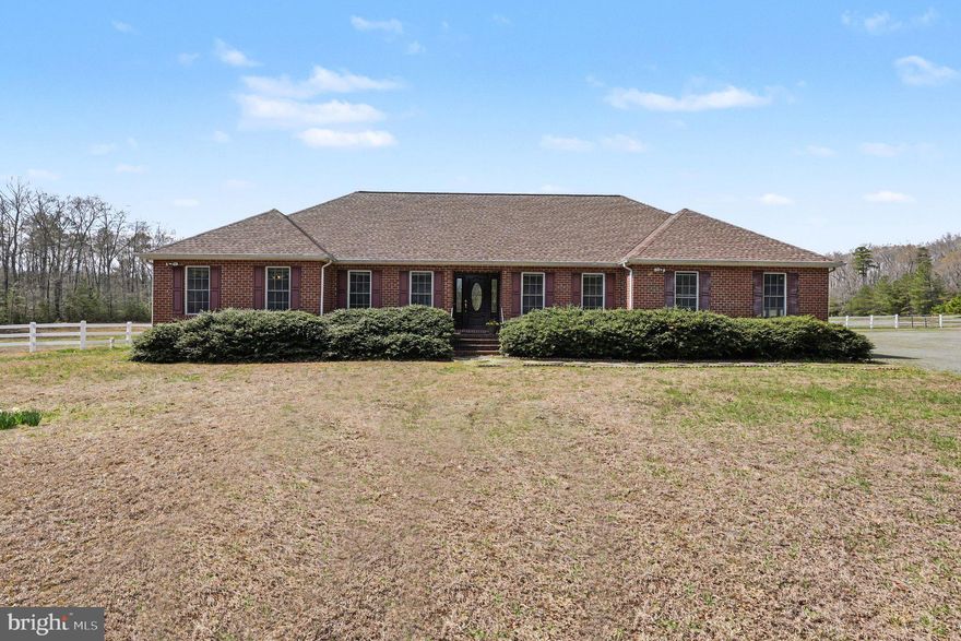 Nestled in the heart of historic Westmoreland County, this custom-built, brick home on a 123 +/- acre parcel known as Spring Garden, presents a rare opportunity to own significant acreage in a peaceful and private country setting.  The property offers approximately 10 +/- acres of cleared land and pasture, surrounded by expansive wooded acreage rich in character and varied terrain. The home offers a comfortable floor plan and 2500 square feet of living space including a family room with gas fireplace that opens onto an inviting screened porch; a spacious, main-level primary suite; two additional upstairs bedrooms with shared bathroom; an office; a separate dining room; and two half-baths on the main level with one serving as a desirable mud room off the garage. The unfinished basement has a walk-up to the backyard and offers wonderful storage space and easy access to mechanicals and utilities.  The attached garage accommodates two vehicles with a third garage door for added convenience.

Your horses and farm animals will be well-accommodated in the metal barn/stable which features four individual stalls, a utility room and ample space for a workshop or equipment storage.   
Established trails meander through the property—ideal for walking, horseback riding, or simply immersing yourself in the natural beauty of the land.  For those with a larger vision, this property could be expanded to become a family compound with additional homes or outbuildings.  Whether you’re seeking a peaceful retreat or outdoor adventures, this property offers a unique combination of privacy, space, and rural Virginia living.