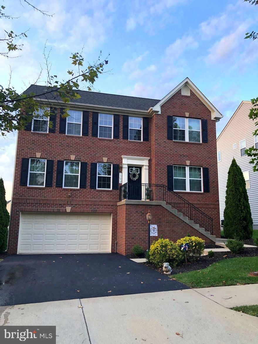 This gorgeous home located in amenity filled Wentworth Green is beautifully maintained and move-in ready! New HIGH SCHOOL OPENING IN 2021!!!  Lovely two-story entry way and stunning main level hardwood flooring. The open kitchen boasts a large center island with seating, stainless steel appliances, granite countertops and a large sunroom/breakfast room with many windows.  Sit in the spacious family room in front of the fireplace with a hot chocolate or coffee.  This family room will accommodate even the largest of families. Walk up to Your beautiful Master bedroom with sitting area which opens to the luxury bath with double sinks and soaking tub. On this level you will find beautiful Plantation Shutters on all windows and also three additional bedrooms, a full bath and the laundry.  Walk down to the finished lower level with recreation room and half bath;  walk out to the covered patio, fully fenced and level yard with plenty of entertainment room and an irrigation system.  Looking for an oversized garage to store cars and motorcycles or just every day lawn equipment?  You got it!  Walk down the community path to Virginia Gateway and the movie theatre, many shops and restaurants.  Easy access to major commuter routes, 66, 29, 28 and VRE. PROFESSIONAL PHOTOS TO BE LOADED SHORTLY.