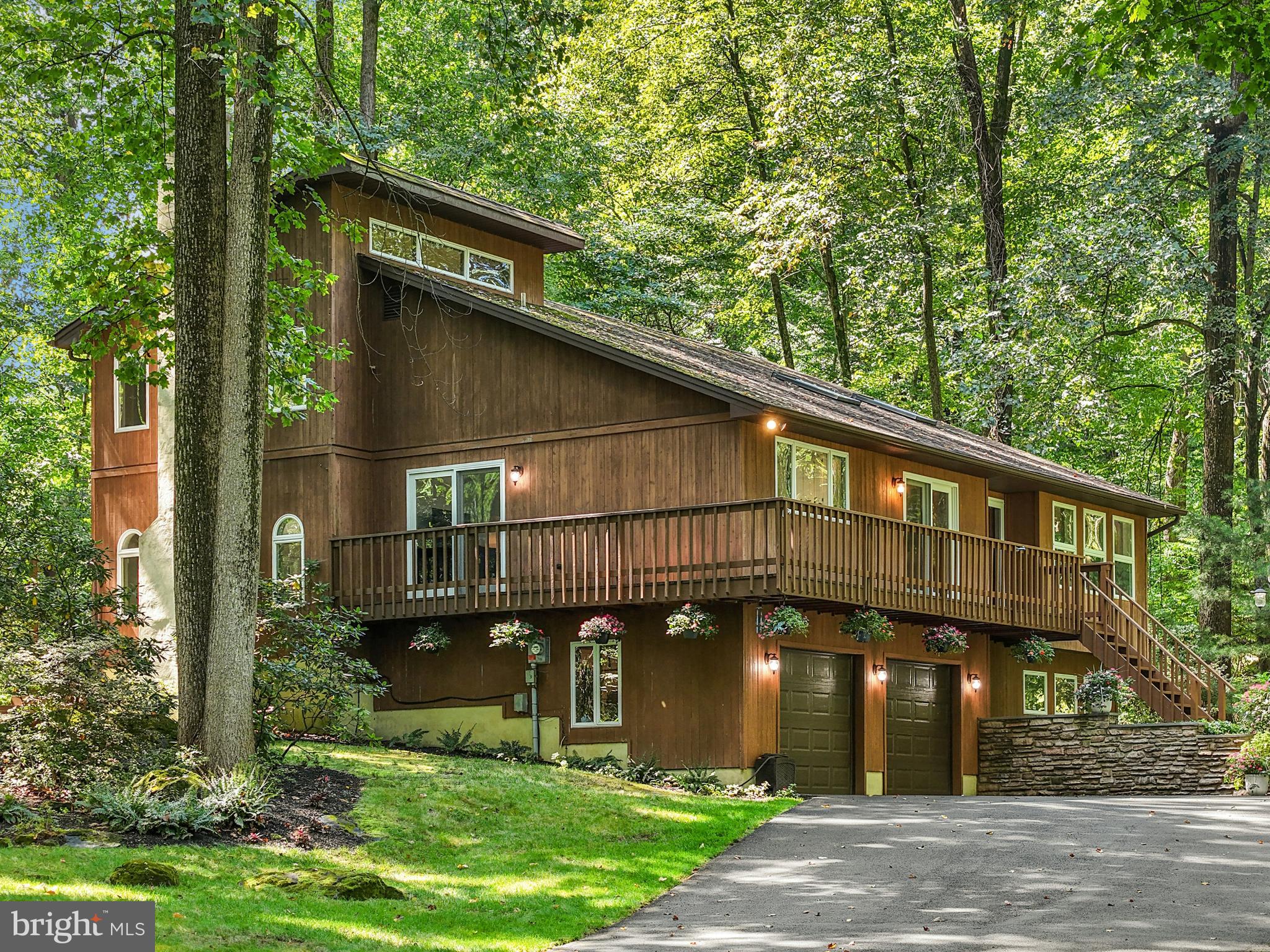 Escape the hustle and bustle as you wind down the long paved driveway to this captivating contemporary home, perfectly nestled on 2.4 private, wooded acres. Offering both tranquility and convenience, this one-of-a-kind property blends spacious living with a serene natural setting.
Step inside to discover a versatile floor plan filled with natural light and generously sized rooms. The vaulted living room welcomes you with gleaming hardwood floors, two skylights, and an open, airy feel. Hardwood floors continue in the elegant dining room, providing plenty of space for gatherings and formal entertaining. The adjacent kitchen, featuring granite countertops, subway tile backsplash, and a cozy breakfast area with deck access, is both stylish and functional.
The family room, anchored by a charming brick fireplace, opens directly onto the rear deck, perfect for relaxing or entertaining with a view of the surrounding trees. A flexible bonus room, also with deck access, offers endless possibilities: a game room, home gym, office, or creative studio. Upstairs, the primary suite is a true retreat, with vaulted ceilings, a vanity area, and a private en suite bath. Two additional spacious bedrooms, with updated flooring, share a hall bath and provide comfort for family or guests.
Outdoors, the wraparound deck invites you to unwind and take in the peaceful woodland views. Whether it’s morning coffee or evening gatherings, this space immerses you in nature while maintaining complete privacy. Move-in ready and ideally located, this home offers the best of both worlds - a private lifestyle with easy access to the Pennsylvania Turnpike and Routes 663 and 309 for convenient commuting.