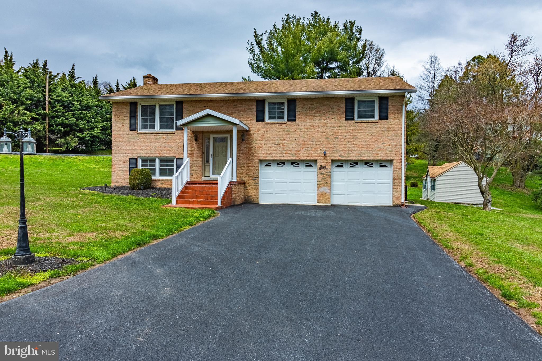 This lovely, one-owner, bi-level home overlooks the town of Annville and sits on a large corner lot in quiet College View Heights. Just off of Thompson Avenue in N. Annville Twp., this 3 BR, 1.5 bath home exemplifies pride of ownership. With fresh, neutral paint throughout, new flooring in most of the house, updated full bath with walk-in tile shower, bright new front door, and replacement windows, this house is move-in ready! The main level includes an eat-in kitchen with oak cabinets and recently updated solid-surface countertops and tile backsplash. A lovely dining area opens into a spacious living room. Three sizable bedrooms and a full bath round out the main floor. The lower level features a large family room with wood-burning fire place and access to the backyard. A bonus room could be used as an office, playroom, or an additional bedroom. The lower level is rounded out with a half bath, laundry room, storage closets, and access to the oversized 26' X21' 2-car garage with extra storage area. A large 16' X 12' utility shed with a new roof provides extra storage for the lawnmower. No HOA fees! Don't miss out on this remarkable, rare find!