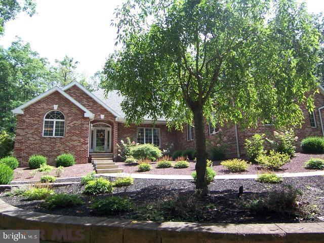 Delightful one-story, brick home found on 4 wooded acres within the SCASD. You'll value the private location, open floor plan and the geothermal heating system. Highlights of the kitchen include Corian countertops, island breakfast bar w/cooktop, stainless appliances, lovely eat-in area and office nook. French doors lead to an inviting sunroom and patio offering ideal areas for taking in the pond water feature and abundant wild life. The vaulted great room is spacious and offers an inviting fireplace and nice natural light. Separated from two additional bedrooms the master suite features two walk-in closets, a full bath with jetted tub and walk-in shower. Also notable: security system, partially finished lower level, gazebo, 3-car garage, and beautifully landscaped.