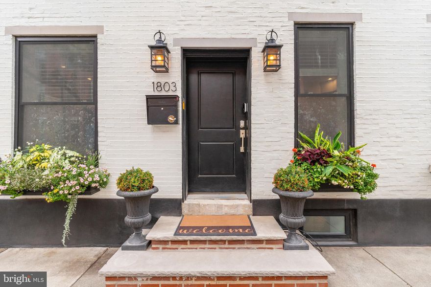 Welcome to 1803 Catharine Street - AKA 779 S. Cleveland Street. This beautifully renovated 3 BD | 2.5 BA corner property is in the heart of Graduate Hospital. 
Enter the front door on Catharine Street into the elegant and airy first floor. On the left of the open tread staircase sits the formal, sun-soaked living room with rich chestnut hardwood floors and four large, updated windows.
To the right of the staircase is a stunning, sunny kitchen with white, raised panel cabinetry and ample storage space. Stone countertops and marble backsplash, a large farmhouse sink and stainless steel GE cafe appliances provide a top of the line culinary experience. The custom pantry cabinet and adjustable island allow residents to design the space to best suit their needs. A side entrance located in the kitchen leads to your private, one car driveway, complete with a Tesla electric car charger.

Make your way down the wide, wooden staircase, past custom bookshelves, to a lofty, tiled basement. Perfect for hosting guests, the basement includes a large living area, a half bathroom, a laundry room with LG appliances and a laundry sink, as well as multiple storage closets.

Ascend the staircase from the first to the second floor hallway, where sunlight pours through two large windows and residents can enjoy the foliage of their trees year round. At either end of the hallway sit two bedrooms, each with dual closets and large windows. Finally, a full bathroom with a glass enclosed tub shower, brass finishes, and a modern vanity completes the second floor.

The home's third floor includes a large bedroom, a private balcony with skyline views, custom cabinetry housing a second LG washer and dryer, a custom linen cabinet, and a grand bathroom. With heated stone floors, a glass and marble steam-shower and two modern vanities flanking the entrance to the custom walk-in closet; this bathroom provides a quiet oasis for home owners.

Ascend the staircase one last time to the newly built roof deck. Here residents can relax in front of the gas fireplace and enjoy 360 degree views of the Philadelphia Skyline, or delve into rooftop gardening.

This home is located within walking distance to the lively commercial district on south street, the Marion Anderson pool and recreation center, and a short walk to Rittenhouse Square. Dual zoned HVAC, a tankless water heater, key pad entry and a top of the line security system are just a few additional perks to this fantastic place to call home.