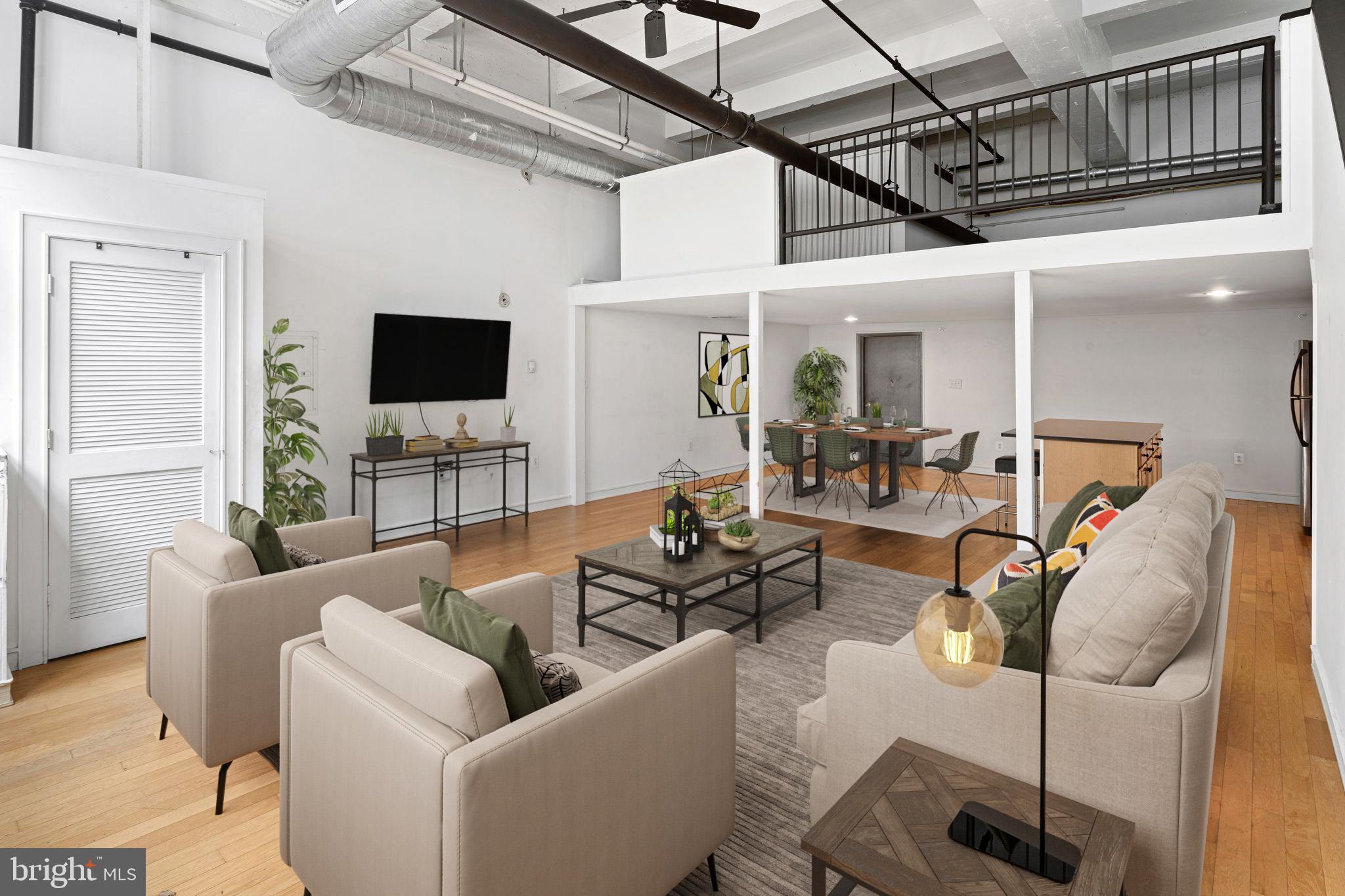Don’t miss this unique opportunity to own a spacious, true loft-style condo with private garage parking right in the heart of Northern Liberties, one of Philadelphia’s most exciting and dynamic neighborhoods! This oversized 1-bedroom loft condo offers over 1,100 square feet of stylish, light-filled space, accompanied by low monthly condo fees, making it a smart and affordable choice, especially for first-time buyers looking to establish roots in one of the city’s most desirable locations at a great price. Set on the ground floor with two secured entrances, the home blends industrial charm with modern functionality. You’ll love the soaring ceilings, exposed ductwork, beams, and natural hardwood floors that give the space its authentic urban-loft feel. The open-concept kitchen features oak cabinetry, granite countertops, stainless steel appliances, and a large island that seamlessly flows into the dining and living areas—perfect for entertaining or simply relaxing at home. The main level also features a full bathroom with light-colored tile and a convenient in-unit washer and dryer. Upstairs, a large lofted bedroom with gray flooring and neutral paint overlooks the living space, creating a fabulous, airy retreat. Residents also enjoy access to a shared rooftop deck—ideal for summer lounging or taking in the skyline views. One covered garage parking space with direct interior access to your unit, providing total convenience and peace of mind. Step outside and you’re truly in the center of everything Northern Liberties has to offer. From local favorites like Café La Maude, Pera, and Urban Village Brewing, to boutique shops, yoga studios, dog parks, and art galleries, everything is just a short stroll away. The lively Piazza, 2nd Street corridor, and Liberty Lands Park bring a perfect mix of energy and community. Additionally, with quick access to public transportation, major highways, and just minutes from Center City, the location is ideal for both commuters and city explorers. Whether you're a first-time buyer seeking the right balance of space, style, and location or an investor looking for a stable rental with strong neighborhood appeal, this Northern Liberties gem checks all the boxes.