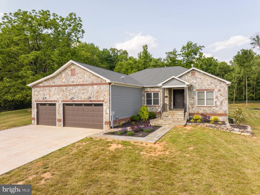 This masterful design will captivate you the moment you arrive at this 2019 custom-built ranch style home. Situated on over 3 acres in this highly sought after gated Potomac River community,  this exquisite home offers 3 bedrooms, 3.5 baths with a home office.  Enjoy this spacious open floor plan featuring gorgeous hardwood floors, upgraded craftsman styled interior trim and 9ft ceilings with a beautiful stone LP fireplace.  The gourmet kitchen boasts top end Kitchen Aid appliances, upgraded cabinetry and quartz countertops , including a glass cooktop and tandem wall oven/microwave. Enjoy gathering and entertaining around this  large island  that has a double bowl sink featuring a reverse osmosis system . The  owner's suite features two walk-in closets and a deluxe owner's bath with double bowl sinks, beautiful marble countertops, and a spacious super shower with floor to ceiling ceramic tile and decorative listello. The two  impressive guest suites each feature large walk-in closets and full baths. The main level offers over 2,300 finished square foot, but you also have 2,300 unfinished square feet in the basement to make your own! The walk out basement has neatly placed  rough-ins to allow for maximized space for framing your future living space including full bathroom rough ins. The basement utilities feature a HE dual LP/electric furnace, top of the line whole house water softener and reverse osmosis system with UV light, pressure regulator, 80gal water heater with heat pump and whole house Kholer generator. This remarkable home's exceptional attention to detail in every room makes this home the only one you will want to see! You will enjoy entertaining guest on your back covered porch that leads to a flagstone patio with a fire pit. The 30x40 detached garage built just this year offers space for 4 additional vehicles or use to store your boat and other equipment. The community offers a private marina that provides access to 8 miles of boatable waters. This stunning home has it all!