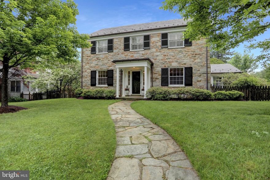 Nestled in the heart of Baltimore’s coveted Homeland neighborhood, this pristine 1950s stone colonial is a rare architectural gem that blends timeless charm with thoughtful updates and unbeatable walkability. Recent major updates include a slate roof,  copper gutters,  shutters (2022), and most windows have been restored, and chimneys relined.  Every detail has been carefully curated for lasting beauty and function.  

Step along the stone walkway to discover a home renovated with utmost care. The formal living room features a wood-burning fireplace flanked by double built-in bookcases, while the elegant dining room is accented by chair rail molding and a stylish light fixture. The kitchen is bright and sunny, designed with custom cabinetry and countertops, stainless steel appliances, an island, and a cozy dining or sitting area.

Upstairs, the expansive primary suite offers a luxurious private bath, complemented by three additional bedrooms and a second full bath. Throughout the home, gorgeous hardwood floors, recessed lighting, and plantation shutters speak to the quality and care throughout. The finished lower level includes new luxury vinyl plank flooring, a welcoming family room, a laundry area, and a half bath, and an extra storage area.

Outside, entertain or relax on the beautiful stone patio with a seating wall, overlooking the level, fenced backyard—perfect for grilling, games of croquet, a bocce match, lacrosse practice, or simply enjoying a quiet afternoon.  The property also includes an attached two-car garage and private rear driveway access.

Beyond the home, Homeland offers an unmatched lifestyle—enjoy historic walking paths, nearby fine and casual dining, the Enoch Pratt Library, and proximity to premier private and public schools, universities, world-class hospitals, and major league sports venues. It's just a short stroll to the iconic ‘Spring Lakes’—ideal for feeding ducks, admiring blooming trees, or spotting a heron. 

Perfectly located for commutes uptown, downtown, or even to Washington, DC, with easy access to Penn Station.  Your patience has paid off—the wait is over. There is no place like Homeland!