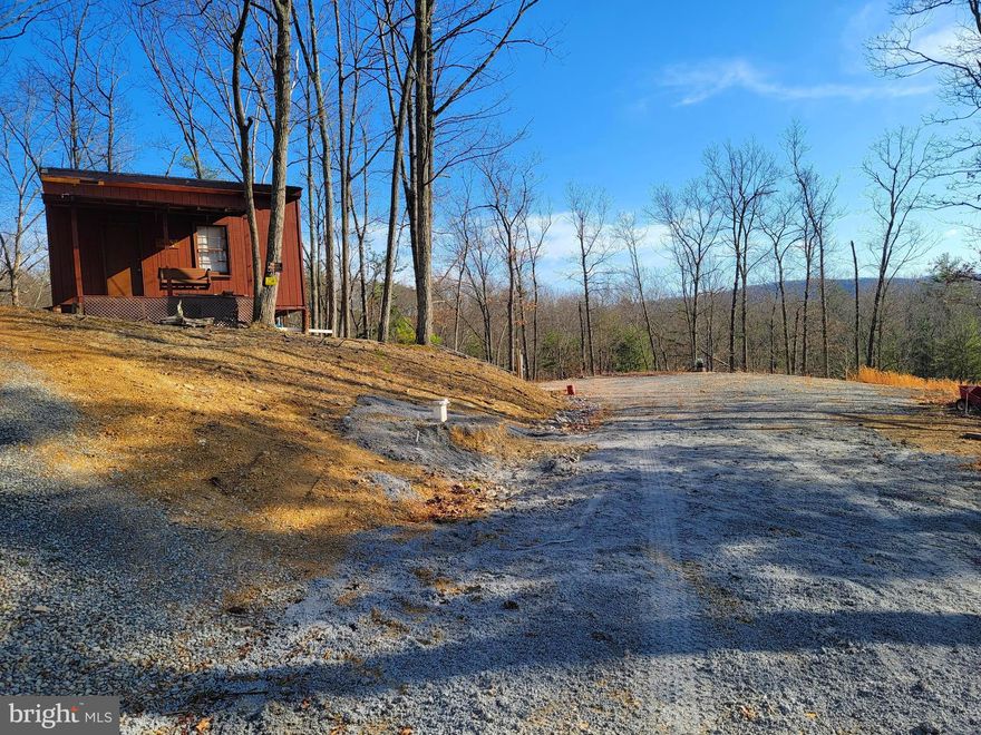 You will feel like you are on top of the world on this beautiful 9.8 ac lot situated in the mountains of Springfield, WV with amazing views. There is a newly installed well and septic  on the lot along with electric and a cleared area where you can set up a camper. An ATV trail is waiting for you to ride your 4 wheeler / ATV and explore the property. The trail even crosses a land bridge over a spring and there are 2 dry creeks that run in the spring. There is a shed that can be used for a hunting camp or to store your toys. Relax on the porch swing after a day of hunting, hiking, or playing in the river and watch for wildlife that roam the hills. You are conveniently located only minutes from the public access to the South Branch Potomac River where you can fish, swim, float or canoe. Call today and make this your weekend get away or where you build your forever home in Almost Heaven, West Virginia!
