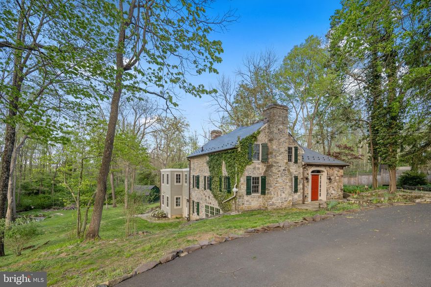 Tucked into Solebury's prime Aquetong Valley within eyeshot of a stunning stone-arched bridge, this three-level, English-style 1650 stone cottage  has had some major updates: NEW slate composite roof with copper gutters and copper snow guards; ALL BRAND NEW windows (even the "newer" ones were replaced), brand new refrigerator, BRAND NEW sumptuous Main Bath AND SO MUCH MORE!!! Deep windowsills, exposed-beam ceilings, 3 beautiful fireplaces  and exposed stone walls add visual interest and texture inside. Outside, extensive tiered, natural-stone patios and a party-sized deck overlooking the rear yard provide plenty of outdoor space for warm-weather enjoyment. The main kitchen/dining area is open with high ceilings, substantial crown molding, recessed lights and French doors opening to a patio and the deck, very convenient to the kitchen for those who enjoy grilling. The kitchen's newer cabinetry, Wolf professional-grade 6 burner range with stainless exhaust hood, built-in Sharp microwave, Bosch dishwasher with cabinet panel, and brand new stainless armoire-style refrigerator/freezer and Quartz countertops complement the character of the house. A handsome porcelain farmhouse sink, breakfast bar and pantry complete the kitchen area. The dining area with fireplace is expansive, able to accommodate plenty of friends and family. The living room with fireplace is divided by the stairwell, a convenient arrangement if someone wishes to watch TV in one area and have a quiet space in the other. Upstairs are two bedrooms that share a Jack & Jill bath with custom shower finished in slate tile with rainfall showerhead and handheld, and vanity with undermount sink. The daylight walkout lower level presents flexible space finished with a bluestone floor. The sizeable main room has a large fireplace and big bay window. A beautiful full bath with tub/shower is nearby as are two additional rooms (fourth bedroom and office or workout space) and a laundry room. A French door opens to a lower terrace. Mechanicals, including heat and central air, are new.  This truly picturesque property is dotted with towering mature trees, weeping willows edging a small pond  and running creek and fresh landscaping around the terraces. With a choice location adjacent to an array of farm estates and renovated living spaces with great indoor-outdoor flow, this is a move-in-ready home that can be your quiet hideaway or a happy gathering place. Enjoy! (Square footage is NOT accurate)