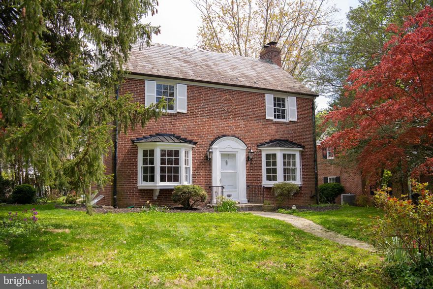 Fall in love with this center-hall colonial! Located on a quiet one-way street in Homeland, features abound in this classic 3 bed 3.5 bath brick home.  The home has a great interior flow which allows for easy entertaining. The large, light-filled living room includes s a gas-burning fireplace and bay window. The dining room is perfect for dinner parties or quiet, home-cooked meals. An easy to manage kitchen with granite counters and stainless steel appliances provides for all of your culinary needs. Also on this level is a huge family room with its own full bath and access to the rear patio. The primary bedroom features plenty of closet space and updated full bath. Two other large bedrooms share an updated hall bath. Original hardwood floors on the main level and second floor., too  The fully finished - and super dry - basement includes retro knotty-pine walls, a spacious utility area, a high efficiency furnace with electric air filter, newer water heater, and a water purification/filtration system for the whole house.  The rear yard has a patio space perfect for morning coffee or afternoon grilling. Plenty of parking in the back, too, with a herringbone brick parking pad and one car garage.  Located incredibly close to local amenities like Belvedere Square, York Rd shopping, Eddies on Charles, and so much more!  Easy access to major travel routes like I-83, I-695, Penn Station, and the light rail.