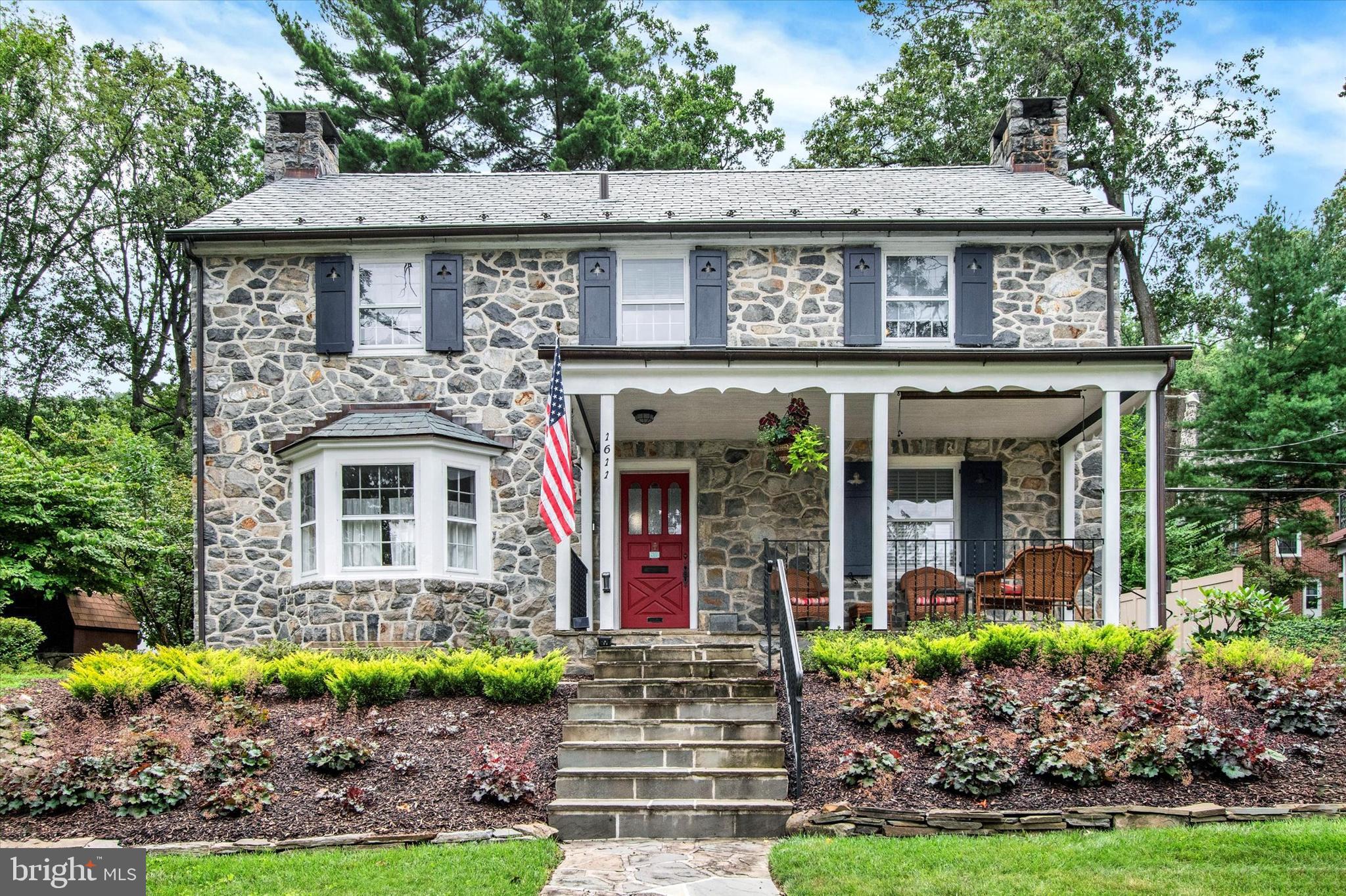 Charm & Character abound at this totally move-in ready and beautiful Stone Colonial, located in the highly desirable Hampden Heights Community. A large flagstone covered porch offers an inviting first impression to this majestic stone home and lot. As you step inside the entrance hall you are greeted by a gracious open staircase and striking refinished hardwood floors. To the left of the center hall is a study or office (could even be a bedroom), and to the right is a large living room with stunning, cozy fireplace . Imagine holiday parties or dinner get-togethers in the large formal dining room. You will love the two built-in China Cabinets that flank the room. The newer kitchen with granite work surfaces and newer stainless appliance fixtures is surely a welcome addition to this classic home. The kitchen’s size provides for a comfortable area for informal dining, plus the convenience of a direct access side porch and another door for access to a two-car garage. The upper reaches are equally beautiful! The staircase railing wraps around the second-floor hall adding to the charm and appeal. Three spacious light filled bedrooms are accessed off the open hall. A lovely new tiled hall bath services the two bedrooms. The primary bedroom provides a walk-in closet with vintage safe, plus newer updated bathroom with tiled shower. The lower level/finished basement area offers a cozy media room with wood beamed ceilings plus a stone fireplace! Additionally, there are two storage rooms and a large utility room with a walk out and up access to the driveway. The slate roof was new in 2014! The Electric was completely upgraded as well as the gas Heat and electric water heater were all completely replaced in 2021. The interior was painted in 2022. Click on the video icon for a virtual tour, on YouTube.