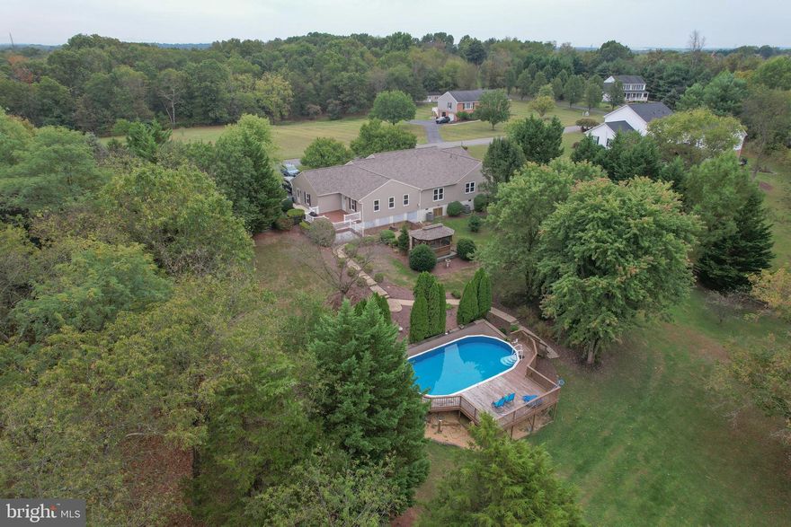 "Elegant Brick Rancher with Pool, Gazebo & 2 Primary Suites”
Welcome to this beautifully updated brick rancher, perfectly situated on a picturesque 2-acre lot. Offering two primary suites along with two additional bedrooms, this home provides an exceptional blend of comfort, flexibility, and style. Gleaming hardwood floors, a gourmet kitchen with gas stove, and expansive room sizes create a warm yet elegant atmosphere throughout.
Step outside to your private retreat, where the fenced rear yard features a charming gazebo, a sparkling above-ground pool with deck, and a well-appointed storage shed. A spacious unfinished basement and 2-car garage add endless possibilities for storage or future living space.
This residence has been meticulously maintained and thoughtfully upgraded with a new roof, siding and windows. Both the hall bath and primary bath were stylishly refreshed.  Additional highlights include three HVAC systems, a cozy pellet stove, luxury vinyl tile in the kitchen, carpeted bedrooms, and hardwood throughout the rest of the home.
Combining timeless brick charm with modern updates and luxurious finishes, this move-in ready property is a rare opportunity in one of Falling Waters’ most popular neighborhoods.