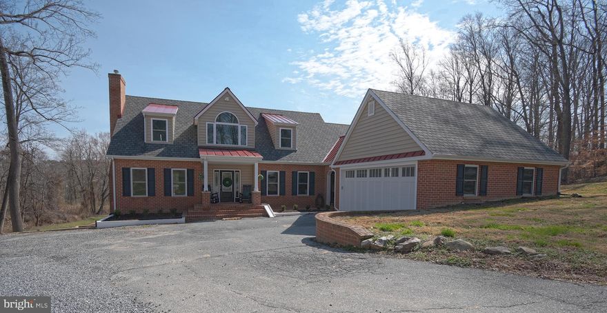 Wait until you see this! Impecably maintained brick house on nearly 20 acres, overlooking a pond with tons of privacy. 2 large outbuildings. High-end upgrades and fixtures. The house has 4 bedrooms and 3.5 baths.  A primary owner's suite on the main floor and an additional owner's suite on the second floor.  Beautiful hardwood floors throughout.  The main floor features a bar room and an office.  Kitchen with marble countertops and a huge professional refrigerator.  Fully finished basement.  2 car attached garage. The first outbuilding is a office space with 2 private offices, a conference room, a gym, kitchenette and half bath.  The second outbuilding features 5 garage bays and a finished area that serves as a family room with kitchenette. This property is nothing short of spectacular.