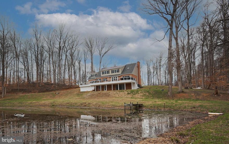 Wait until you see this! Impecably maintained brick house on nearly 20 acres, overlooking a pond with tons of privacy. 2 large outbuildings. High-end upgrades and fixtures. The house has 4 bedrooms and 3.5 baths.  A primary owner's suite on the main floor and an additional owner's suite on the second floor.  Beautiful hardwood floors throughout.  The main floor features a bar room and an office.  Kitchen with marble countertops and a huge professional refrigerator.  Fully finished basement.  2 car attached garage. The first outbuilding is a office space with 2 private offices, a conference room, a gym, kitchenette and half bath.  The second outbuilding features 5 garage bays and a finished area that serves as a family room with kitchenette. This property is nothing short of spectacular.