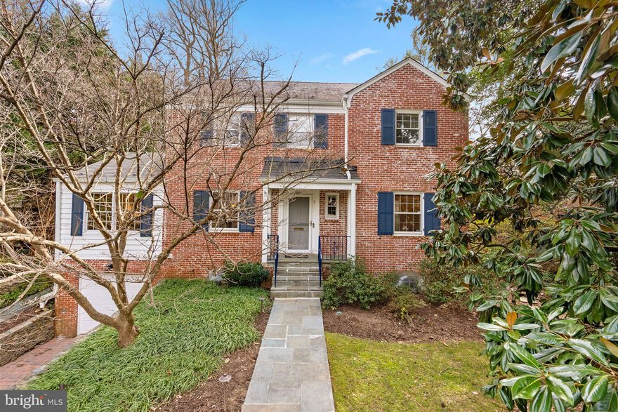 Fabulous new price! Chevy Chase - Rollingwood | This home is nestled in a bucolic enclave suited for both relaxing and commuting. Located between Bethesda and Silver Spring, this prime location makes it is easy to take Beach Drive into the city. Iconic Rock Creek Park is minutes away on foot with direct access to Candy Cane City Playground, Meadowbrook Stables, and the paved 8.6-mile Rock Creek hiker-biker trail. 
As you enter through the foyer on the main level you find a formal dining room, a formal living room with a fireplace and a wall of windows, an office with built-ins, a powder room, and a substantial kitchen offering dining and sitting areas with vaulted ceilings. Glass doors open to the expansive rear terrace with a gas grill for ease of outdoor entertaining. The second level offers a primary bedroom with attached bathroom and walk-in closet. Bedrooms 2 and 3 share a hall bathroom. The third level has a bedroom 4 and an office. The lower level, with access from the attached garage, has a spacious family room and bedroom 5  with a full bathroom. The gardens are beautifully landscaped including outdoor lighting, stone retaining walls, and stone terracing. There are a security system and an electric car charger installed.
This home offers a rare blend of space, comfort, and convenience in a welcoming neighborhood.