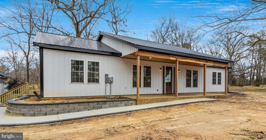 New Construction on 7.26 acres! Ready in less than 30 days. Stunning and truly unique Pole-Barn house with huge detached 3-car garage.  Home boasts amazing details through-out including wide plank poplar-wood ceilings with beams, and shiplap accent walls.  Kitchen with gorgeous quartz counters, huge center island, Stainless Steel appliances, custom wooden range hood, and open shelving framing the farmhouse kitchen sink. You will love the wide-open floor plan between the Kitchen/dining/living which showcases the gorgeous beamed ceiling details. Split bedroom plan with master at one end and 3 additional bedrooms at opposite end of home. Master features HUGE walk-in closet, tiled shower, and dual farmhouse sinks. 2nd bath also features dual sinks and 6 ft tub. Gorgeous stamped concrete flooring through-out entire home and extremely tasteful fixtures and lighting. You do not see craftsmanship and details like this every day!  All this plus barn already set up for horses, large fenced pasture area and plenty of room to spread out! This one is a must see!  More photos coming soon.