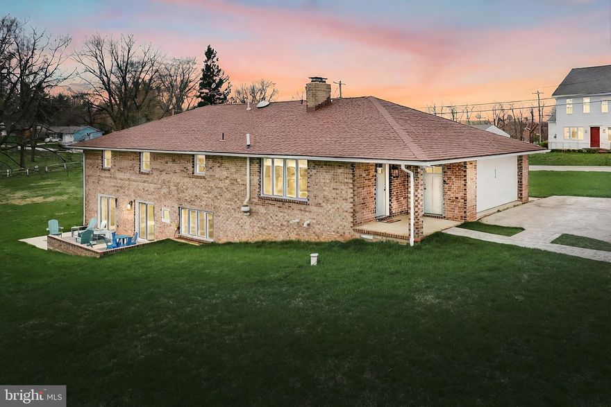 Don’t miss this rare opportunity to own a stunning, superbly renovated brick home centered on a level 1 acre parcel with panoramic country views in Dallastown School District! The handsomely appointed Rancher has been upgraded inside and out with the finest taste and an attention to detail immediately evident as you step through the door. Offering 2 finished levels with a total of 5 bedrooms and 2 full baths, the contemporary layout provides an open feel and flow that can gracefully accommodate a variety of living arrangements. The main floor is fully equipped for one-level living, with both front and side entrances, convenient laundry/mud room, generous living room, exceptional oversized quartz and tile kitchen with superior grade appliances, including double oven and beverage chiller, large island and breakfast bar, and adjacent dining room with covered patio access and perfect views of the surrounding landscape. 3 large main level bedrooms enjoy ample closet space and a brand new custom tile bath with quartz vanity, deluxe walk-in shower and built-in storage. The fantastic daylight lower level is perfect for extended family or guests, comprising a huge family room with exposed brick accent walls and mantle with built-ins, electric stove and flue for wood stove, numerous windows, kitchenette and wet bar area with slider to the rear patio, a second palatial custom tile bath and two additional bedrooms, one with a private slider to the patio overlooking picturesque scenery, ornamental blooms and vast verdant lawn ready to host your outdoor plans. Abundant natural light is supplemented throughout the home with LED recessed lighting. New HVAC system, whole house water filtration system, reverse osmosis drinking water dispenser, and tankless hot water heater ensure every comfort. The 440 sqft. 2-car garage includes workshop area, and is supplemented by a broad paved driveway parking area. Every detail has been carefully addressed in this better-than-new home! The location is equally enticing, just outside of town but within blocks of schools, restaurants and local shopping, and moments to time-saving commuter routes. Your only care will be arranging your furniture and scheduling your housewarming party when you make this delightful residence your own. Welcome home!