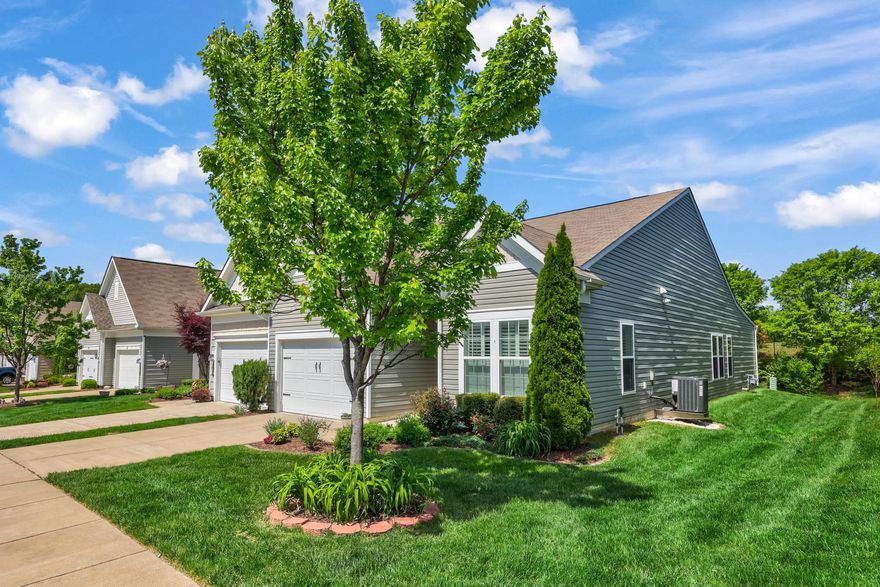 Welcome to this beautiful end-unit villa, which offers abundant natural light and a peaceful setting that the homeowners have truly appreciated. Located in the amenity-filled, 55+ Celebrate VA community, this 1600+ square foot home features one-level living with two bedrooms plus a versatile flex room, ideal for a tv room, home office, or more. The open floor plan seamlessly connects the kitchen, dining, and living room, which is highlighted by a cozy fireplace—perfect for both everyday living and entertaining.  The upgraded kitchen boasts a large center island, a modern backsplash, and plenty of workspace. A rear bump-out creates a bright sunroom-style area, adding extra living space and charm. Engineered hardwood floors and plantation shutters throughout enhance both style and comfort. Step outside to enjoy the private backyard and back deck complete with an awning—perfect for relaxing or entertaining outdoors. Additional features include a new A/C unit in 2025, a spacious one-car garage and a separate laundry room. This home combines low-maintenance living with thoughtful upgrades in a quiet, desirable setting that backs to trees and farmland.  Celebrate VA amenities, including the 30,000+ square foot Riverside Lodge Clubhouse with an indoor pool and spa, walking track, fitness center, billiards area, a ballroom with a kitchen, and more. The lovely grounds boast an outdoor pool, tennis and pickle ball courts, bocce court, large patio with gas grills, and an amphitheater. Call for your tour today and come join the Celebrate VA lifestyle!