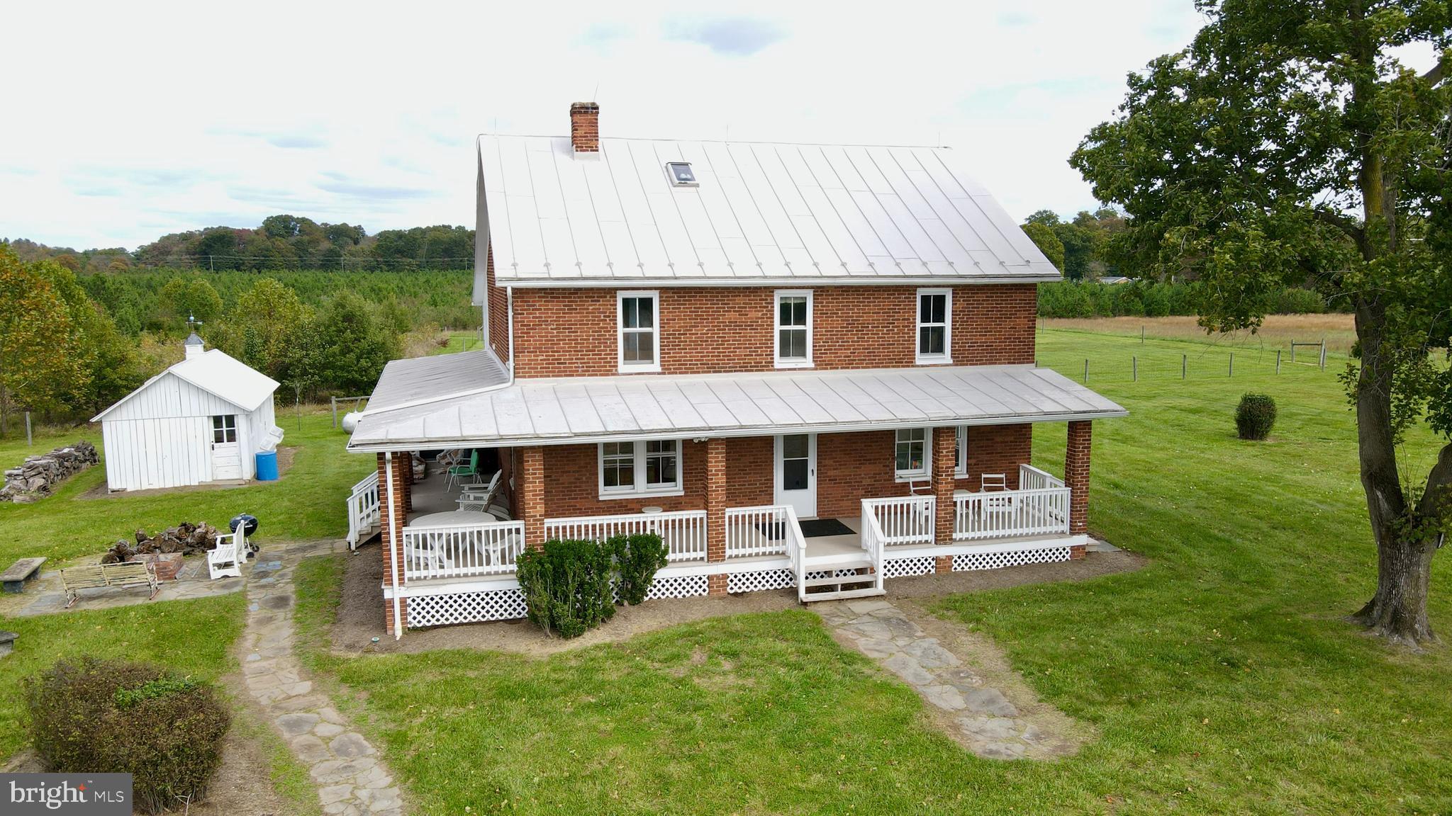 Experience quintessential Virginia country living with this extraordinary two-story brick farmhouse in Leesburg, VA. Situated on over 227 acres of picturesque farmland, this 4-bedroom, 2.5-bathroom home combines historic charm with modern amenities. Enter to find hardwood floors throughout, exuding warmth and timeless appeal. The eat-in country kitchen, complete with stainless steel appliances, granite countertops, and ample cabinet space, flows seamlessly into the dining and living rooms—ideal for both everyday living and entertaining.
A highlight of this home is the fully enclosed sleeping porch, offering a cozy, versatile space perfect for relaxation or enjoying the surrounding views in comfort year-round. Step outside to a classic wraparound porch, where you can unwind with unobstructed views of Sugarloaf Mountain. The property offers extensive hard-surface road frontage on Lucketts Road and Saint Clair Lane, providing multiple access points. A large equipment shed with a workshop can cater to a variety of uses, while two serene ponds and rolling farmland create a peaceful retreat. Additionally, over 7,200 planted pine trees are growing on the property, enhancing its natural beauty and future possibilities.
For those seeking even more land, two adjacent 20-acre lots are also available for purchase, offering expanded options for development, recreation, or investment.
A prime location for commuters, this property is just minutes from the Point of Rocks train station, providing easy access to city amenities while maintaining a rural lifestyle. Enjoy the best of Northern Virginia’s countryside with nearby historic downtown Leesburg, award-winning vineyards, and scenic trails. Don’t miss this unique opportunity to own a legacy property that epitomizes Northern Virginia charm and serenity. Schedule your tour today and let this Leesburg treasure captivate you!