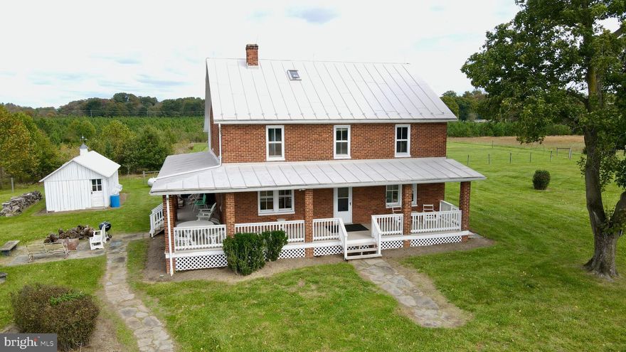 Experience quintessential Virginia country living with this extraordinary two-story brick farmhouse in Leesburg, VA. Situated on over 227 acres of picturesque farmland, this 4-bedroom, 2.5-bathroom home combines historic charm with modern amenities. Enter to find hardwood floors throughout, exuding warmth and timeless appeal. The eat-in country kitchen, complete with stainless steel appliances, granite countertops, and ample cabinet space, flows seamlessly into the dining and living rooms—ideal for both everyday living and entertaining.

A highlight of this home is the fully enclosed sleeping porch, offering a cozy, versatile space perfect for relaxation or enjoying the surrounding views in comfort year-round. Step outside to a classic wraparound porch, where you can unwind with unobstructed views of Sugarloaf Mountain. The property offers extensive hard-surface road frontage on Lucketts Road and Saint Clair Lane, providing multiple access points. A large equipment shed with a workshop can cater to a variety of uses, while two serene ponds and rolling farmland create a peaceful retreat. Additionally, over 7,200 planted pine trees are growing on the property, enhancing its natural beauty and future possibilities.

For those seeking even more land, two adjacent 20-acre lots are also available for purchase, offering expanded options for development, recreation, or investment.

A prime location for commuters, this property is just minutes from the Point of Rocks train station, providing easy access to city amenities while maintaining a rural lifestyle. Enjoy the best of Northern Virginia’s countryside with nearby historic downtown Leesburg, award-winning vineyards, and scenic trails. Don’t miss this unique opportunity to own a legacy property that epitomizes Northern Virginia charm and serenity. Schedule your tour today and let this Leesburg treasure captivate you!