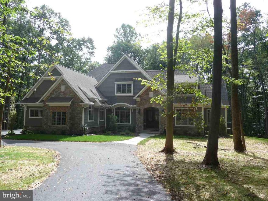 Spectacular new custom home by Greystone Construction features an open plan with gourmet kitchen, great room with vaulted ceiling and fireplace and a casual hearthroom that leads to large deck. First floor master suite with enormous closet and custom bath. First floor study, beautiful hardwood floors, 3 bedrooms and 3 full baths on the second floor. Walk-out basement leads to a beautiful wooded setting. 3 car attached garage.