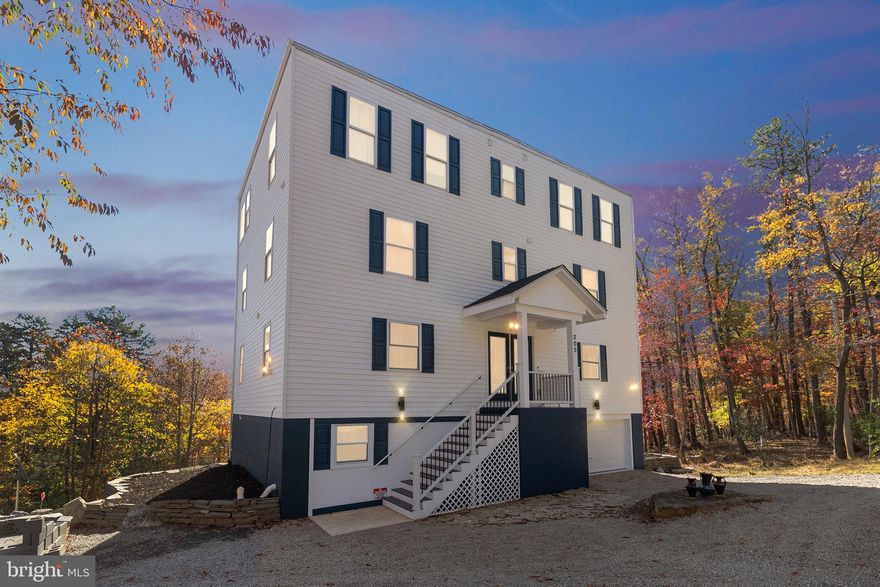 An exceptional 4-level luxury custom home built to capture the stunning mountain views, with easy access to drive and enjoy the scenery from your bedroom, game room, kitchen, and more. The heart of the home is the modern kitchen, featuring an expansive quartz island with waterfall edges and state-of-the-art smart appliances. The top-floor game room offers a wet bar and custom oversized windows that frame the spectacular mountain views, with two private balconies—one off the game room and another off the top-floor bedroom suite. There are three large bedrooms, each with walk-in closets and direct bathroom access. Altogether, the home offers three full bathrooms and two half bathrooms. Additional features include two large storage closets, double glass entrance doors, a top-of-the-line washer, dryer and water filler, a one-car garage, a movie theater, custom railings, and a circular driveway for easy in and out access or ample additional parking for guests. As an added bonus, an extra total half-acre lot in the neighborhood provides private access to a creek, creating a peaceful retreat and offering the potential for fishing. This property is truly a rare find, offering luxury, privacy, and spectacular views (and additional lots totaling over 1.5 acres!).