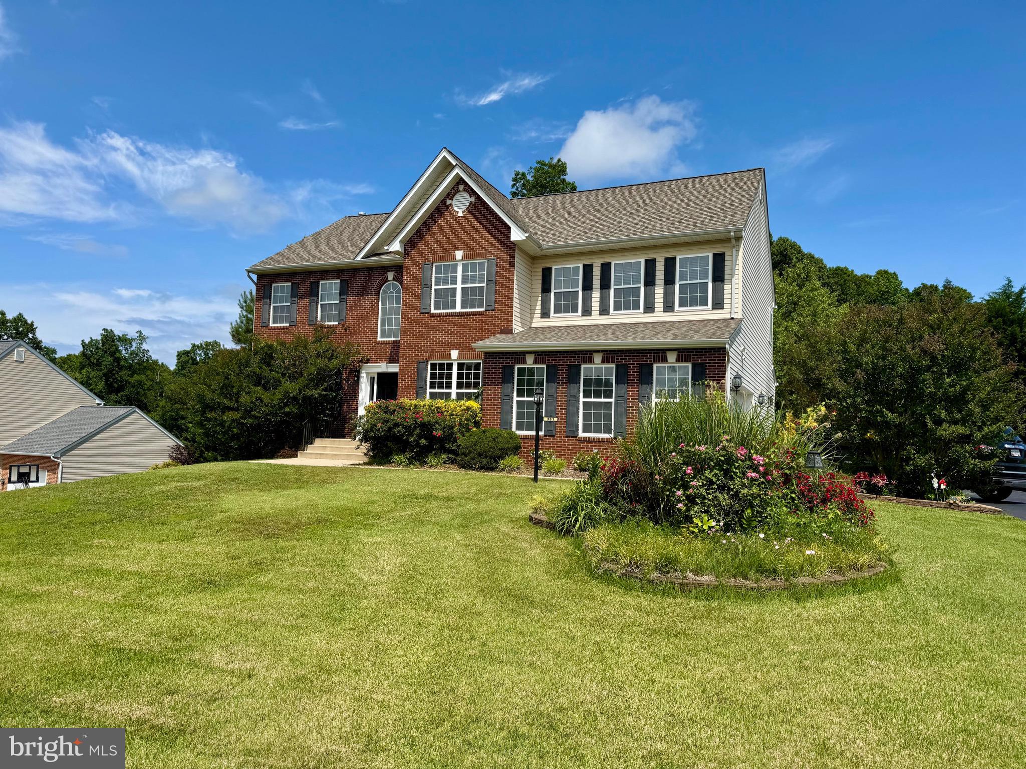 GORGEOUS brick front colonial with 5,200+/- SF including THREE FULL BATHS ON THE TOP LEVEL! No need to add extra time onto your commute from this centrally located Lorin's Pride neighborhood, just off Rte 4 in Huntingtown! You'll love the large owner's en suite with a huge sitting room that could also serve as a nursery or a personal office space. Owner's bedroom has vaulted ceilings, spacious walk-in closet and a bath with a walk-in Tuscany tiled shower, soaking tub and double vanities. Upstairs you'll also find a full sized laundry room and three large bedrooms, INCLUDING A BEDROOM WITH A PRIVATE FULL BATH plus a 'Jack-and-Jill' full bath shared by the remaining two bedrooms. Kitchen has 42" custom maple cabinets, stainless steel appliances, including a 5-BURNER GAS COOKTOP & DOUBLE WALL OVENS! A generous island with granite countertops and pendant lights is perfect for entertaining. The focal point of the family room off the kitchen is a floor-to-ceiling stone fireplace (gas). Enjoy summertime grilling from the low maintenance composite deck, and store all your supplies in the underground storage beneath. Main level has plenty of room to gather-- or to spread out-- with a separate dining room, living room, half bath and a home office. The lower level is where the party's at, with a theatre room complete with projector and screen, a large rec room, and an existing waterline hookup (for a wet bar to be installed). Has a full bath and plenty of room in the unfinished storage area to easily add a 5th bedroom, if needed. Mechanicals have been updated; NEW DUAL ZONE HEATING & AIR HVAC SYSTEMS IN 2023, new hot water heater in 2025, new roof in 2019. Septic was pumped in 2024 and has new dual pumps and a new septic alarm system installed. Has a 2-car Garage with a new wifi garage door opener, plus a double wide paved driveway for extra parking. The .78 acre lot is beautifully landscaped and has a significant side yard that stretches to the corner of the street (to the grouped mailboxes). Home has been freshly painted and carpeted throughout! Located near top rated school system including Huntingtown High School. Near shopping, grocery stores, restaurants, hospital and movie theatre. Easy commute to Joint Base Andrews and Washington DC! *Is VA assumable.